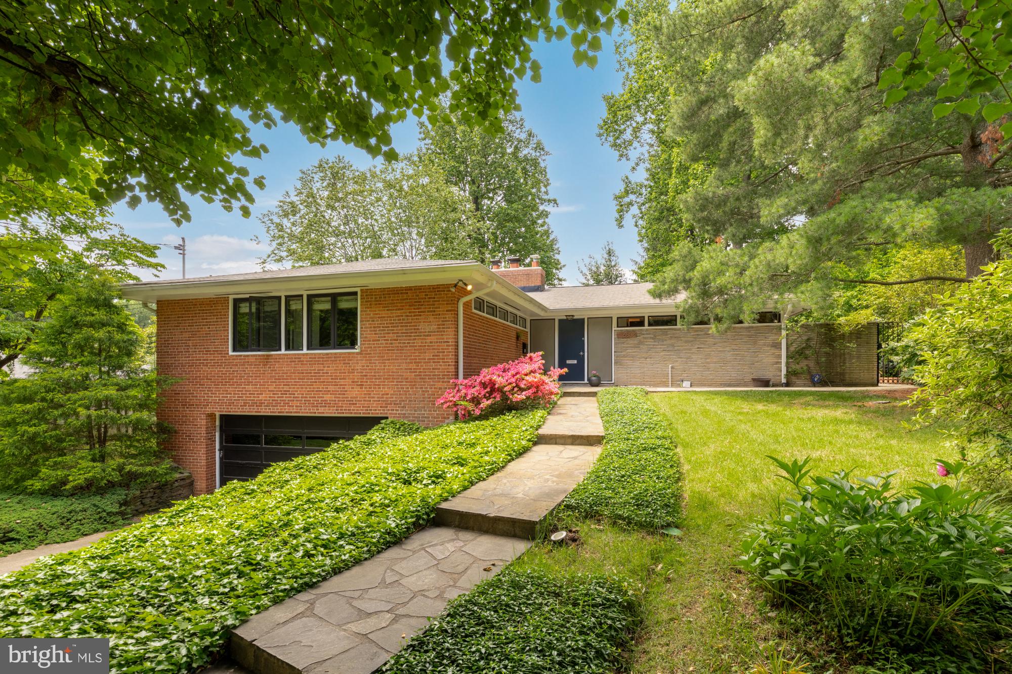 Welcome to this unassuming yet stylishly updated and expanded mid-century modern gem, ideally located in the highly desirable Bradley Hills/Pyle/Whitman school cluster. This thoughtfully designed home blends architectural character with modern upgrades, offering an open and inviting layout perfect for both indoor and outdoor entertaining and everyday living. You'll experience the "wow" factor when you walk through the front door and are greeted by vaulted ceilings, walls of windows and bright open spaces.

Highlights include:
4 Bedrooms | 3 Full Bathrooms
Oversized 2 car garage
Spacious, light-filled living areas

Elegant living room opens to a stone patio and private garden oasis

Bright family room with fireplace

Updated eat-in kitchen with oversized island, new countertops, and stainless steel appliances looks out to private fountain/option koi pond.
Generous primary suite with ample closet space and fully renovated spa-like en-suite bath with separate shower and soaking tub and heated tile floors
Two additional main-level bedrooms + renovated hall bathroom

Mudroom/pantry for added convenience

Walkout lower level with bedroom, full bath, family room/office, space for home gym and storage

Recent Upgrades & Features:
Skylight & light tube (2021)

HVAC system (2017), ducts cleaned (2023)

Water heater (2023)

Renovated primary bath (2023)

Renovated main-level hall bath (2014)

Kitchen upgrades:
New countertops (2012)
Dishwasher, built-in refrigerator, microwave (all 2022), Stove (2013),
Washing machine (2022)
Roof replaced (2012)
New 6” gutters (2021)
Attic insulation (2014)

Additional Features:
African wood live-edge fireplace mantle
Australian wood live-edge hallway shelf
Two-way bedroom blinds
New doors in laundry, bathroom, and hallway closets
Stone patio and planters (2017)
Professional landscaping (2013–2025)
Gutter drain line installation (2019)
Koi pond and waterfall filtration system (2021)
Chimney repointed, repaired, and re-lined
Modern stair railing and light fixture (2014)

Prime Location:
Enjoy the convenience of quick access to I-495 and I-270 for easy commuting, and proximity to parks, trails, shops, and dining. This home truly offers the perfect blend of form, function, and location.