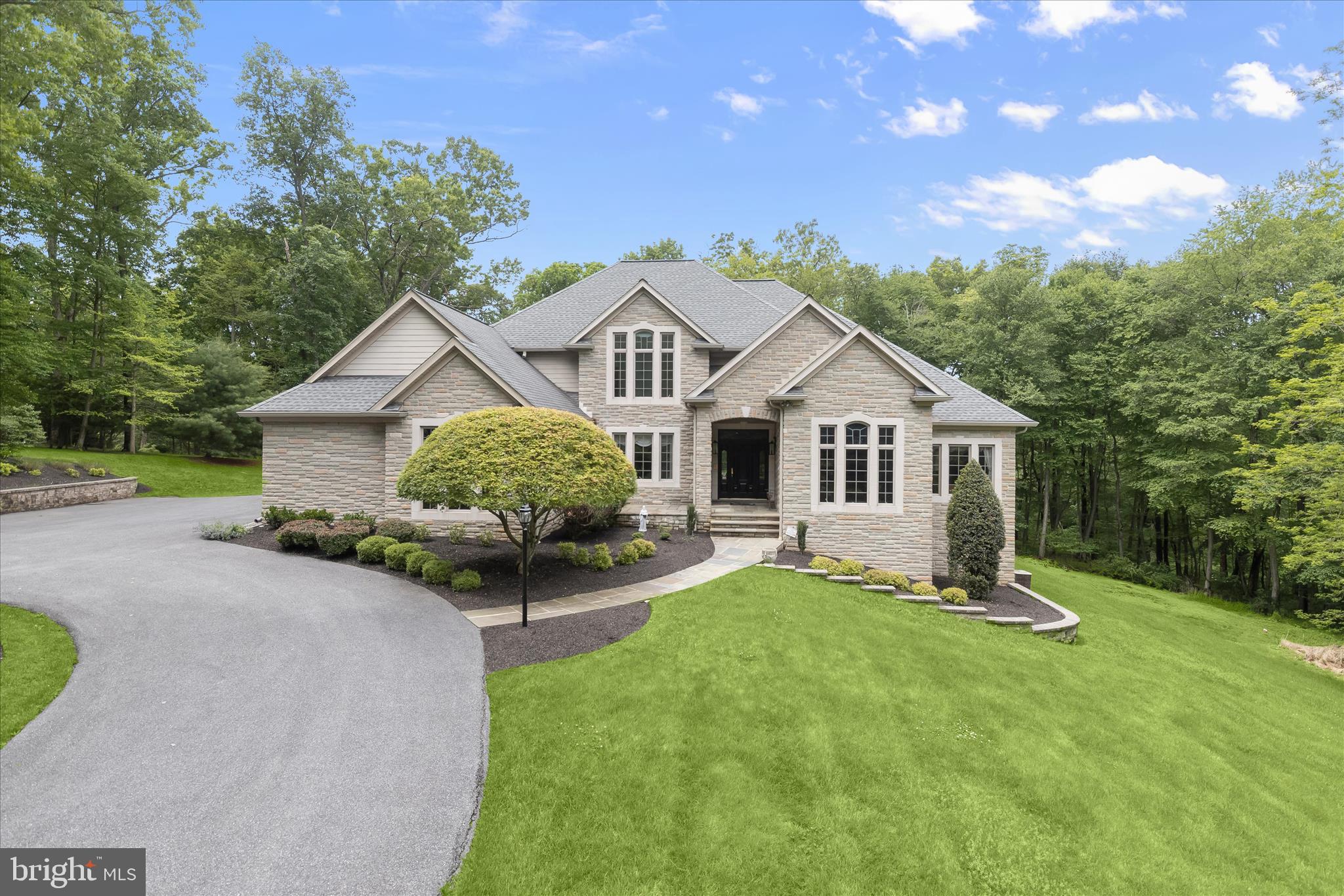 Welcome to 2400 Summerfield Drive, a stunning custom-built estate set on an exquisite 3.17-acre homesite in the highly sought-after Preserve at Beaver Creek Estates. Built by Robin Ford, one of only two builders in the state that is part of the prestigious Southern Living Custom Builder Program, this remarkable residence showcases timeless craftsmanship and elegant architectural detail throughout, including a dramatic two-story foyer with a curved staircase, graceful arched doorways, and rich hardwood flooring. 
Formal living and dining rooms set the tone for refined entertaining, with the living room featuring a bow window, fireplace, and built-in shelving, while the dining room is enhanced by a tray ceiling, classic wainscoting, and hardwood floors. The chef’s eat-in kitchen is a showpiece, complete with granite countertops, a center island with wine fridge, sleek stainless steel appliances, cooktop, double wall ovens, display cabinetry, breakfast bar, two walk-in pantries, and a bright breakfast room. Just off the kitchen, the family room impresses with its stone fireplace flanked by built-ins, cathedral ceiling, and direct access to the custom slate patio, along with a back staircase leading to the upper level.
A private office with French doors and built-in bookcases offers a quiet workspace on the main level, while the luxurious primary suite serves as a true retreat, featuring a sitting room with built-ins, two walk-in closets, and a spa-inspired en-suite bath with soaking tub, glass-enclosed shower, dual vanities, private water closets, and direct access to the patio. Additional main-level conveniences include a laundry room, powder room, and entry to the attached four-car garage with epoxy flooring.
Upstairs, two bedrooms share a full bath, while a fourth bedroom enjoys access to a versatile bonus room ideal for a studio, office, or additional living space, complemented by an additional full bath. The lower level expands the living area with a spacious game room, wet bar, full bath, and extensive storage. Outdoors, professionally landscaped grounds, a circular driveway, custom slate patio, and secure storage complete this extraordinary estate. Blending luxury, privacy, and thoughtful design, this home truly embodies refined Maryland living at its finest.