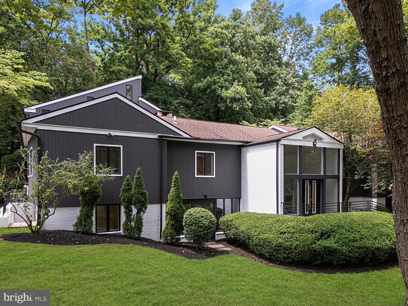 Discover a truly one-of-a-kind, fully renovated modern retreat offering over 5,800 sq. ft. of luxury living. Tucked among the trees on a private wooded lot, this stunning home delivers a peaceful escape just minutes from the Wallingford and Rose Valley train stations, I-476, and the charming shops and restaurants of Media.
Step through grand double doors into a light-filled open-concept living space featuring cathedral ceilings, expansive windows, and skylights that bring the outdoors in. The great room centers around a striking floor-to-ceiling fireplace and flows seamlessly into the chef’s kitchen, complete with Thermador appliances, quartz countertops, butler’s pantry, and breakfast nook overlooking the woods. Sliding doors lead to a patio with built-in grill, perfect for entertaining.
The owner’s level is a true sanctuary with a private foyer, luxurious primary suite, spa-inspired bath with freestanding tub and walk-in shower, and walk-in closet. This level also includes a fitness area, home office/study, and sauna.
The main floor offers a guest suite with private bath, plus three additional bedrooms and a full hall bath. The fully finished lower level features a media/theater room, family room with fireplace, full bath, bonus room with exterior entrance, and a 3-car garage—ideal for an in-law or au pair suite.
Two tranquil creeks border the property, yet the home is not in a flood zone (no flood insurance required). With timeless design throughout, this residence is a statement of sophistication and style.