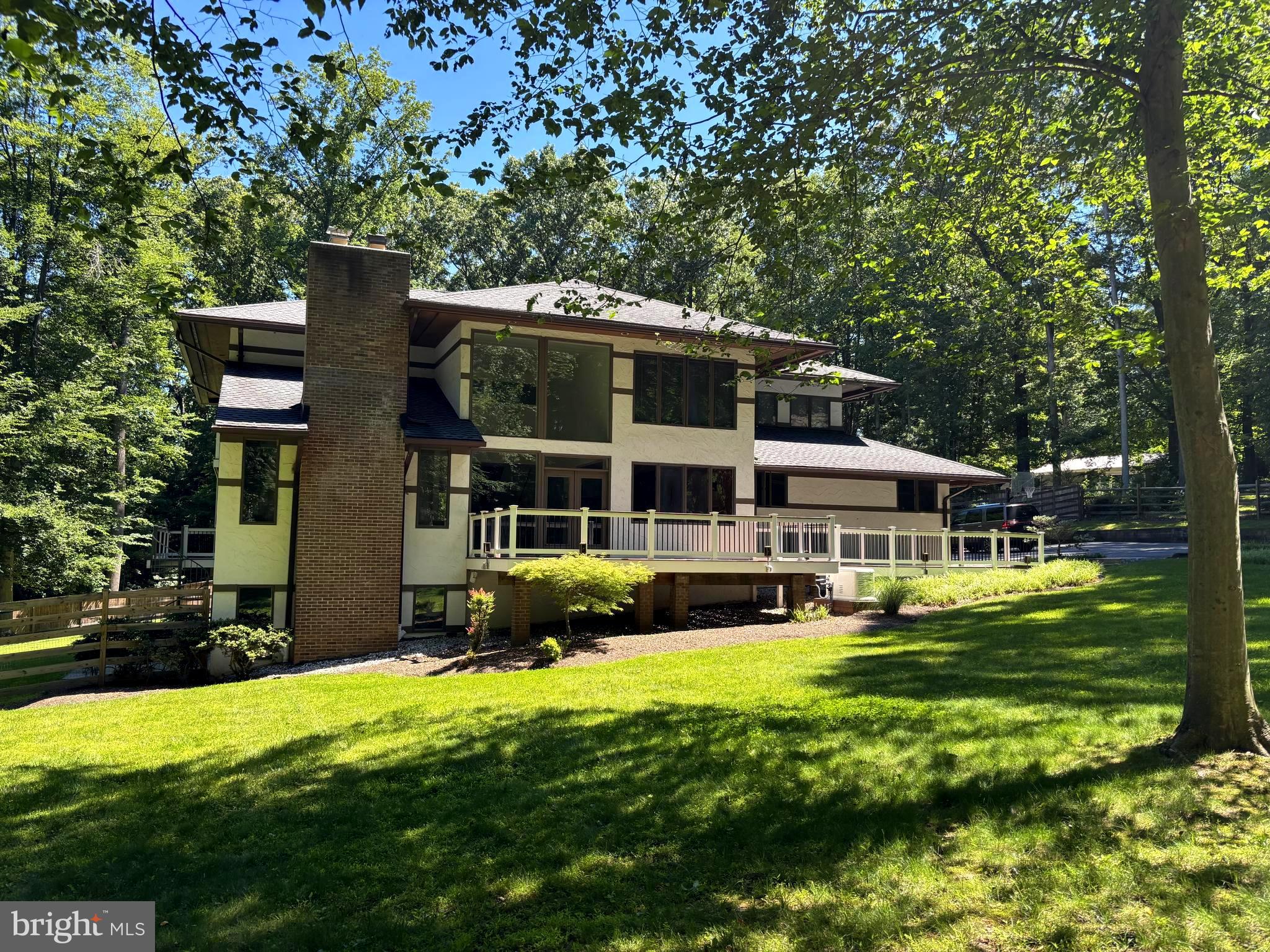 Positioned at the crest of 2.27 private tree-lined acres, this light-filled generously built contemporary is a true 5-bedroom home where walls of glass, soaring ceilings, and gleaming hardwood floors create an immediate sense of calm and openness. At its heart, a fully reimagined gourmet kitchen with stone counters, high-end stainless appliances, and a sun-drenched breakfast area opens to the deck and flows effortlessly into fireside family and living spaces made for both quiet evenings and lively gatherings. A dining room
perfect for entertaining and a family room anchored by a fireplace set into a stone wall round out the main level — each with its own access to the wraparound deck and patios overlooking the grounds. Upstairs, the private primary suite is a sanctuary unto itself: a private balcony, its own fireplace, a wet bar, dual walk-in closets, and a spa bath with jacuzzi tub, oversized tiled shower, and separate WC. Three additional oversized bedrooms share two beautifully updated hall baths, while the walk-out lower level adds
a fifth bedroom / home office, full bath, and generous recreation space that flows out to a slate patio and the serene backyard. A home where seclusion, light, and timeless design make every day begin and end with beauty. For the investment minded this property has significant potential to be subdivided into two lots. The property is 2.27 acres and is located in a 1 acre per lot zone (buyer must verify zoning), has substantial frontage on South Glen Road, and has city water and sewer.

✨ Recent Improvements (over $350K invested since 2022):
🌳 Selective tree removal & professional re-grading of the rear yard
🌲 New privacy trees lining the front
🐾 Fully fenced rear yard
🍳 Complete gut renovation of the gourmet kitchen
🛁 Two fully updated upper-level hall baths (new tile, tub, vanity & fixtures)
🔲 New large-format tile flooring throughout the lower level
🏠 Roof repairs plus a new roof over the kitchen wing
💧 All gutter drains replaced with buried 6″ PVC lines
🔌 24KW whole-house generator with buried 1,000-gallon propane tank

📍 Close to:
🛍️ Potomac Village (grocery, cafés & dining)
🛒 Westfield Montgomery Mall
🌲 Great Falls, the C&O Canal & Potomac River trails
🏞️ Cabin John Regional Park
⛳ Premier golf & country clubs
🚗 River Road, I-495 Beltway & I-270 — easy into Bethesda, DC & Virginia

🏡 Special Features:
🔌 24KW whole-house backup generator
🛁 Jacuzzi primary bath + wet bar
🔥 Multiple wood-burning fireplaces
🌳 2.27 private, tree-lined, fully fenced acres
🎓 Potomac ES · Herbert Hoover MS · Winston Churchill HS
🏠 Walk-out finished lower level with 5th bedroom