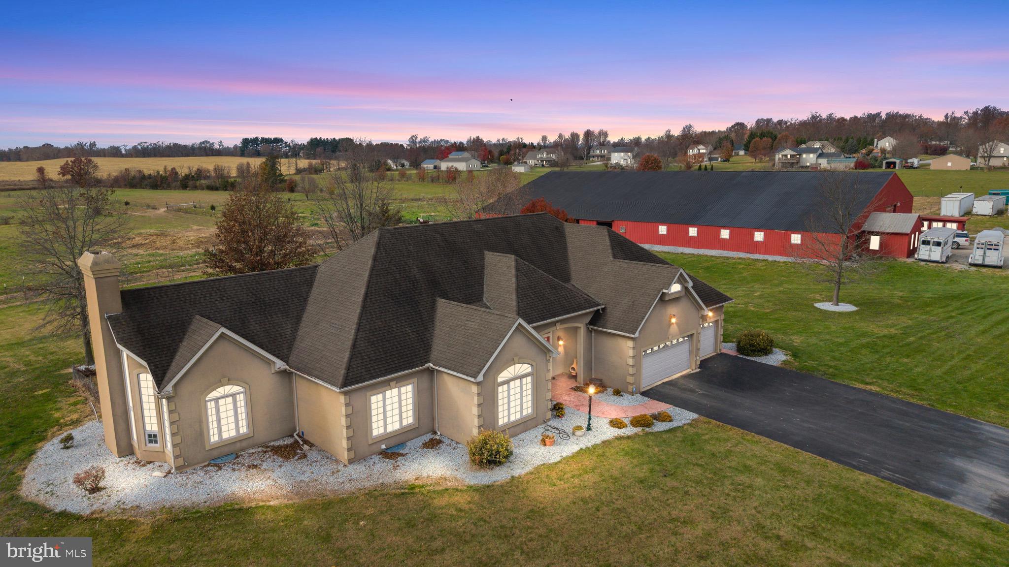 334 Rolling Lane, Abbottstown, PA – One-of-a-Kind Equestrian Estate

Welcome to this remarkable 26+ acre equestrian estate nestled in the heart of Abbottstown, Pennsylvania. Perfectly designed for the passionate horse enthusiast, this exceptional property features fenced pastures, an indoor riding arena, multiple stalls, and an on-site office, providing a true turn-key setup for boarding, training, or private enjoyment.

The centerpiece of the property is a custom-built 3,200+ sq. ft. home, thoughtfully crafted with comfort, elegance, and functionality in mind. Step inside to a grand living area with soaring 20-foot vaulted ceilings that flow seamlessly into the open-concept family room and gourmet kitchen. The chef’s kitchen is a showstopper, featuring granite countertops, custom cabinetry, a large island, and a cozy fireplace, perfect for entertaining or relaxing evenings at home.

This beautiful home offers three spacious bedrooms and three full baths, including an impressive owner’s suite with dual primary bathrooms and serene views overlooking the rolling pastures. A separate formal dining area and abundant natural light throughout create a sense of warmth and sophistication.

Outside, enjoy the peaceful setting with a private pond, open skies, and breathtaking panoramic views of your fenced acreage. Conveniently located near Route 30, this property offers easy access to nearby towns and amenities while maintaining privacy and tranquility.

Whether you’re a professional equestrian, hobbyist, or simply seeking the perfect countryside retreat, 334 Rolling Lane delivers an unparalleled blend of luxury living and equestrian excellence