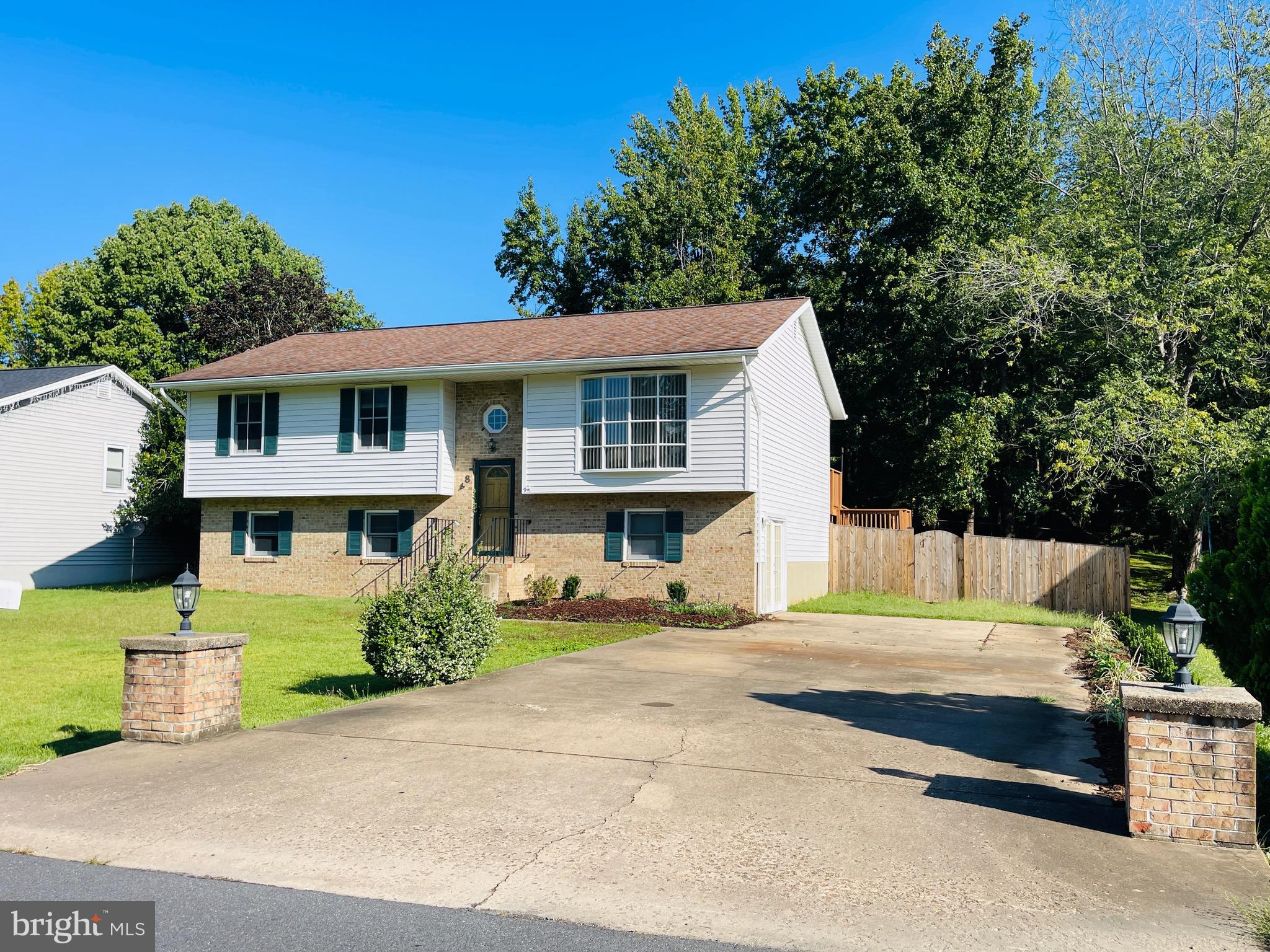 This open and spacious 4 bedrooms home plus office and 3 full bathrooms is located on a large picturesque treed lot in Vista Woods.  The home has updates throughout.  There is a large living room combined with dining on the upper level that opens onto the rear deck and yard.  The lower level has a large open walk out family room plus a private 4th bedoom, bathroom and additional office with built ins.  The master bedroom on the upper level has an ensuite.  The home sits back off the road and has a very large extended driveway for ample off street parking.  Vista Woods is zoned for sought after Mountain View High School plus has an additional elementary and middle school within the neighborhood in walking distance.  Close by is shopping, micro brewery, gym, salons, restaurants and much more.  Only a short drive to Quantico TBS.