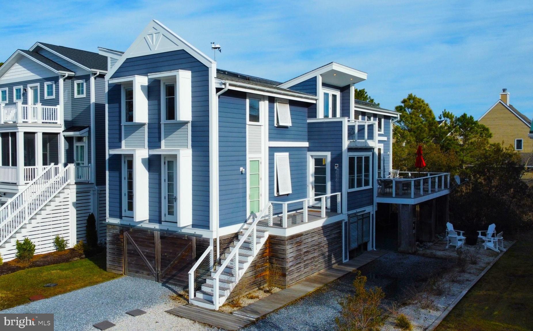 Gorgeous coastal home located less than a mile to the beach! While this home is technically a 3 bedroom, it lives like a 5 bedroom with ample areas that can be utilized for additional sleeping space and was crafted with beautiful millwork details throughout. The impressive great room features a soaring ceiling and an open floorplan combining the kitchen with the dining and living area and multiple sets of glass doors opening to a large deck. The gourmet kitchen offers beautiful cabinetry, granite countertops, gas range, double wall ovens and a large breakfast bar with seating. Also on the main level is a den with barn doors that easily doubles as additional sleeping space, a spacious guest bedroom, full bathroom, and a primary bedroom with en-suite bathroom, wine fridge, sink, drawer dishwasher and separate entrance. The upper level offers an additional family room also with barn doors providing extra sleeping space, and the owners bedroom featuring a large walk-in closet with custom built-in storage, and a spa-like bathroom with a soaking tub and glass enclosed tile shower. Below the home there is a large conditioned space perfect for a game room, an outdoor shower, and an electric charging station. This home was built with our planet in mind, utilizing eco-friendly solar panels, geothermal and a tankless hot water system, along with exterior and interior shades to keep out the sun and heat. Offered fully furnished, this home is ready to be enjoyed or makes a great rental investment opportunity. Situated in a quiet community within walking distance to downtown Bethany. When spending the day on the beach, ride the trolley or use your Town of Bethany parking permits to park downtown to easily transport your beach chairs and accessories.