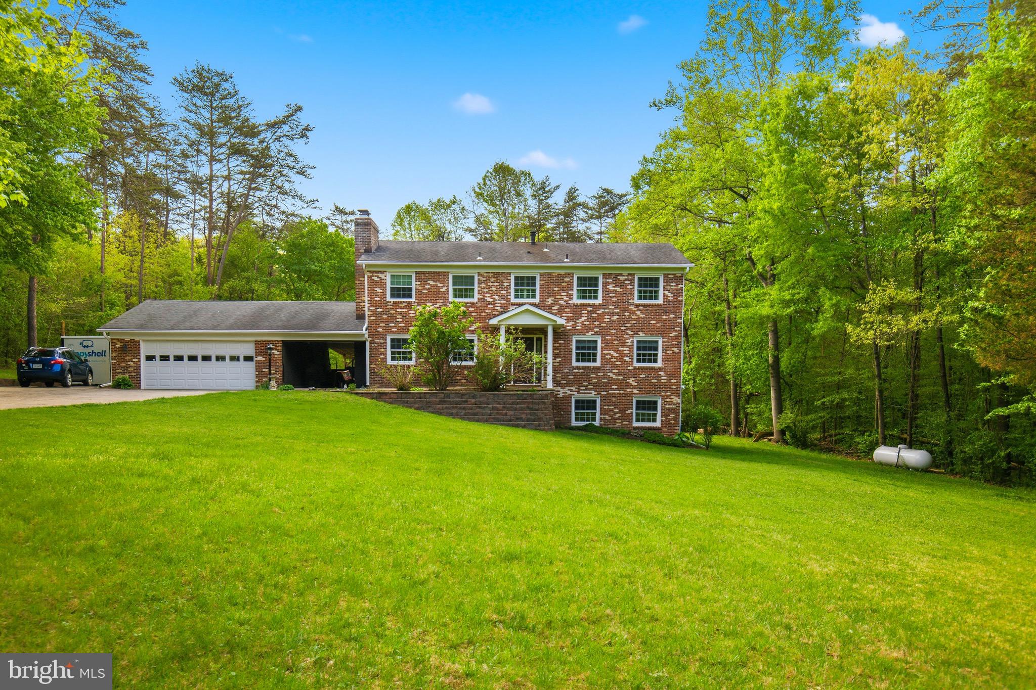 Stately brick colonial home in the secluded and sought-after Greenbrier Estates neighborhood. Situated on a private cul-de-sac, this oversized residence features 4 bedrooms, 2 full bathrooms, 2 Half bathrooms, and a 2-car garage. With over 3,400 square feet of living space on more than 5 acres, the property offers ample room for multi-generational families, including potential for an ADU, a small barn for horses, chicken coop, or parking for an RV, boat, or work vehicles. Notably, the property is zoned A1 with no HOA.

The main level offers a timeless layout with a formal dining room with a wood stove and an eat-in kitchen that flows into a family room with a large bay window. The kitchen includes a French glass door leading to a spacious deck and a beautiful yard highlighted by mature trees and a creek bed that runs through the rear of property.
The second floor contains two spacious bedrooms and a large primary suite with an updated bathroom. The walk-out lower level includes a private entrance, making it ideal for an in-law suite or tenant use. This level features an additional bedroom and bathroom, along with an entertainment area complete with an additional fireplace, bar, tap, mini-fridge, and microwave.
Conveniently located just minutes from I-95, Route 66, 28, 234, and the VRE, this home is perfect for commuters. It is also near historic Old Town Manassas, Shopping, Dining, Great Schools, the Manassas Regional Airport, and local parks like Dove’s Landing,  Prince William Forest Park which offers access to the Broad Run River.

Upgrades 
New shower upgrade in primary bath 2025
Basement bedroom remodel 2026
New attic fan 2024
Replace metal drain under drive way 2018
New ceramic cook top 2011
 New refrigerator 2021
Chimney mortar repair 2024
Leaf guard whole house 
5 new double pane windows   New French doors basement 
New furnace and heat pump 2017
New propane tank 2017
New front door with metal security frame 
Remodel main level