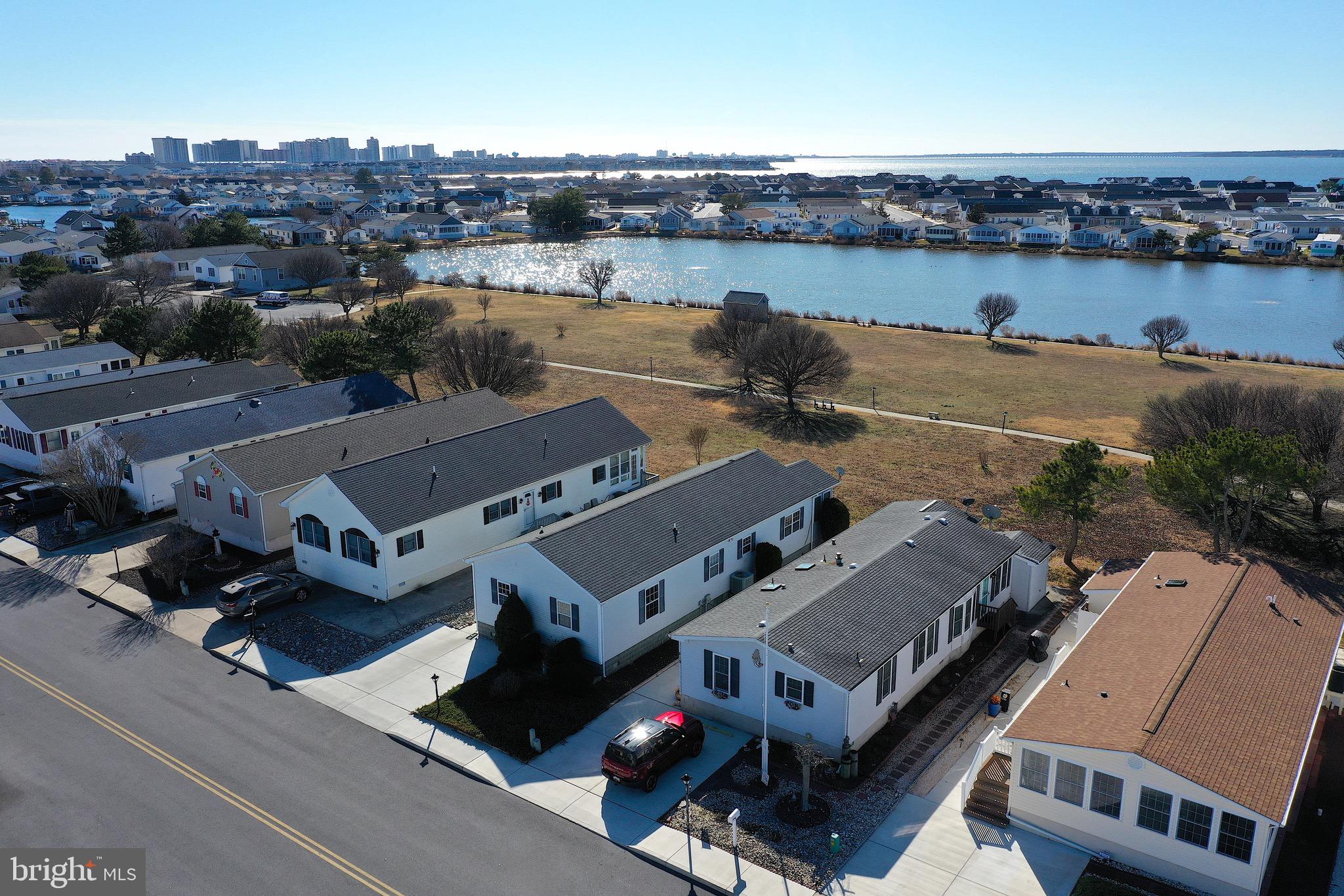 Welcome to coastal living in Montego Bay, one of North Ocean City’s most sought-after communities. This 3-bedroom, 2-bath home offers a peaceful setting with attractive waterviews, no ground rent, and has been lightly used and never rented. The bright sunroom addition provides additional living space and a perfect spot to relax and take in the surroundings. The property has been thoughtfully and extensively updated, making it truly move-in ready. Improvements include a new roof, new heat pump, new water heater, luxury laminate flooring throughout, and fresh interior paint. Additional upgrades include new French doors leading to the sunroom, new ceiling fans, all-new window treatments, new mattresses, and brand-new furnishings throughout the home. The kitchen features all new appliances, offering modern style and convenience.
Outside, the driveway and sidewalks have been completely redone, enhancing curb appeal. Residents enjoy access to two outdoor pools, tennis courts, a community fishing pier, and scenic walking trails, all just a few blocks from the beach, Northside Park, dining, and entertainment. Schedule your showing today!