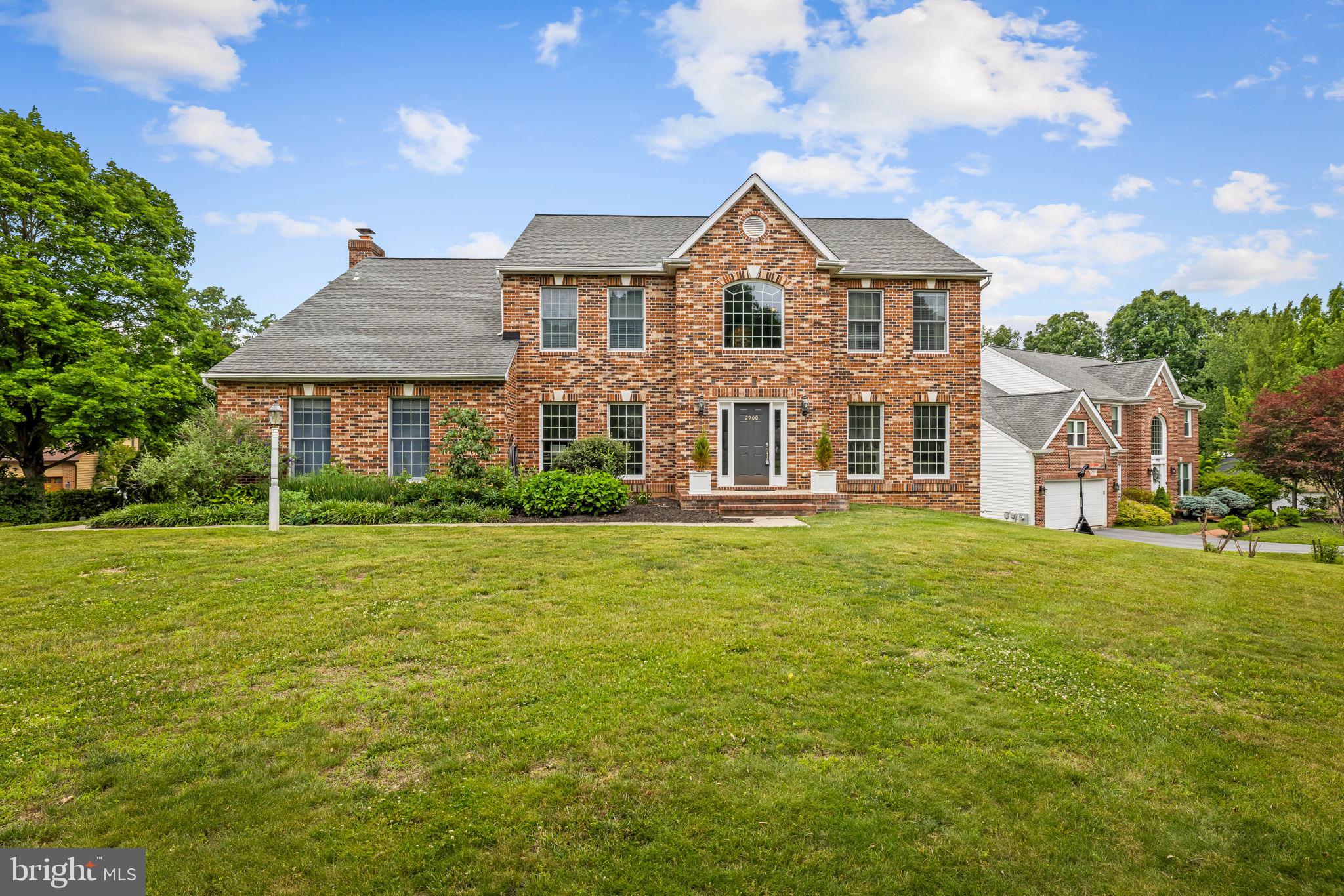Welcome to 2900 Blowing Rock Court, a beautifully appointed home in the highly sought-after Turf Valley Overlook. Ideally situated on a premium corner lot, this home offers exceptional curb appeal and convenient access to Turf Valley's amenities including the golf course, shopping, dining, major commuter routes and top ranked schools! Inside, you'll find a thoughtfully designed floor plan featuring all the spaces today's buyers desire. Rich hardwood flooring flows throughout the main level, beginning in the impressive two-story foyer. The chef's kitchen showcases on-trend white cabinetry, granite countertops, a massive center island perfect for gathering, and upgraded stainless steel appliances, including a natural gas range. The adjoining sun-filled breakfast area provides the perfect spot to enjoy your morning coffee. The spacious family room features a cozy wood-burning fireplace and serves as an inviting space for everyday living, while the formal living and dining rooms with decorative moldings are ideal for entertaining. A private main-level office and convenient laundry room complete the first floor.  Upstairs, you'll find four generously sized bedrooms, all featuring brand-new carpet, along with two beautifully updated full baths. The luxurious primary suite offers a peaceful retreat with a large walk-in closet and a spa-inspired bath featuring a double vanity with granite countertops, soaking tub, and separate shower. The fully finished walk-out lower level provides exceptional versatility and offers brand-new carpeting throughout. A large recreation room with a bar creates the perfect setting for entertaining, while the fifth bedroom with adjacent full bath is ideal for guests. An additional flex room offers endless possibilities as a home gym, office, playroom, or hobby space. Combining an exceptional location, spacious design, and numerous updates, this is a wonderful opportunity to enjoy the best of Turf Valley living.