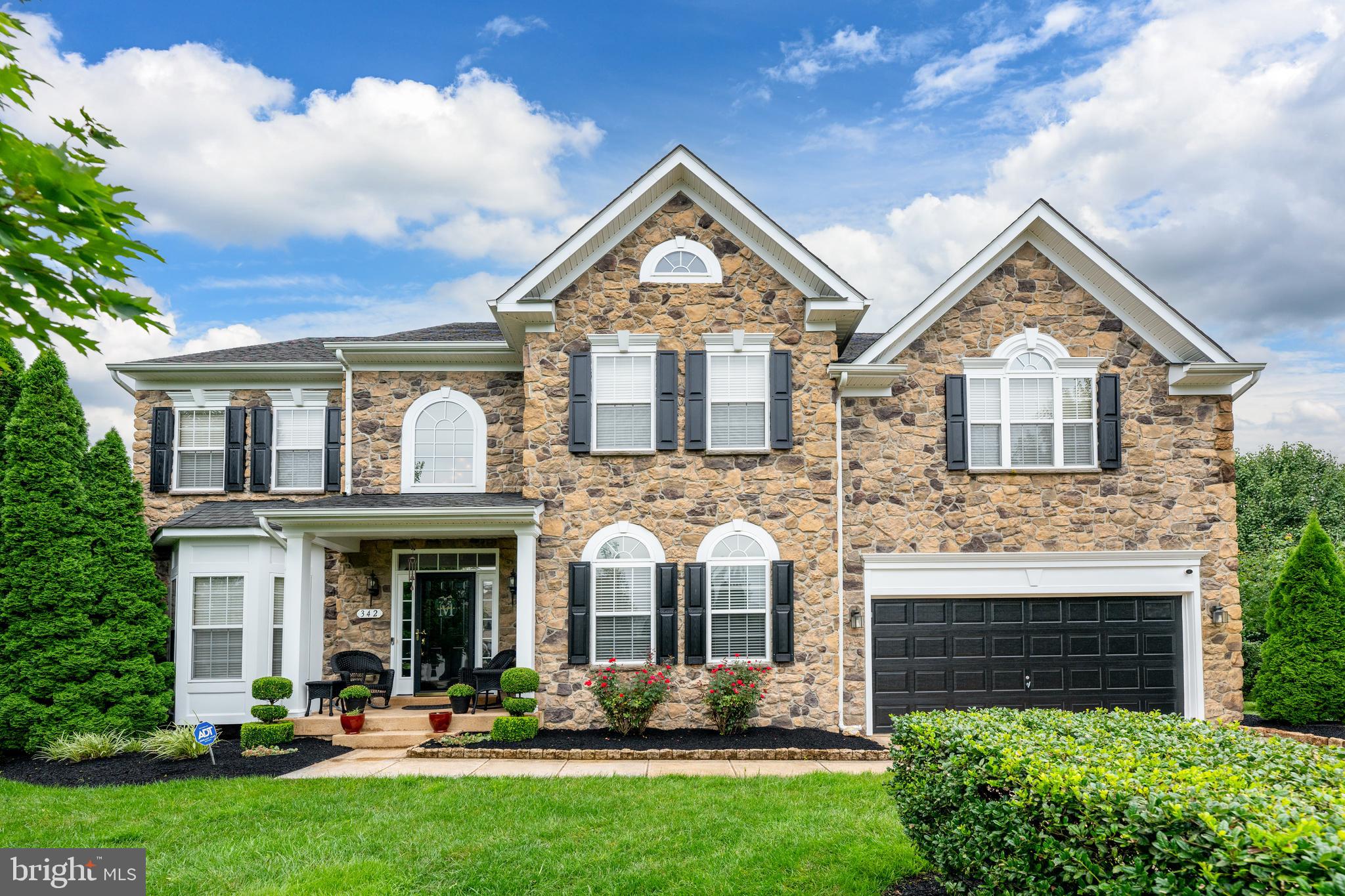 Welcome to your dream home—an exquisite 5-bedroom, 3.5-bathroom stone front estate nestled on a beautifully landscaped ½-acre lot, surrounded by lush, tree-lined privacy. With over 5,300 sq ft of finely crafted living space, this two-story masterpiece seamlessly blends timeless elegance with modern luxury!
Step through the covered front porch into a dramatic 2-story open foyer where you will be greeted by a  breathtaking chandelier.  To the right, double French doors will invite you into the first-floor office which provides a quiet and elegant workspace.  To the left a sizeable formal living room accented with a bay window and enhanced by chair rail and  triple crown molding followed by the formal dining room. Gleaming hardwood floors flow throughout the majority of the main level, leading to a spacious gourmet kitchen featuring stainless steel appliances, a Jenn Air gas cooktop, double wall ovens, granite countertops ,recessed lighting, additional crown molding, upgraded cabinets and lighting fixtures. The adjoining sunroom invites natural light and overlooks the lush, meticulously landscaped backyard.  Cozy up by one of the home's three gas fireplaces—perfectly situated in the great room, basement, and master suite.  Upstairs, the master suite is a retreat of its own, boasting tray ceilings with crown molding, double door entry, recessed lighting,  attached sitting room with 3-sided gas fireplace, two expansive walk-in closets complete with custom shelving and shoe racks, and a step up spa-like ensuite bath.   The luxurious ensuite is it's own sanctuary featuring double door entry, upgraded tile, an oversized jetted whirlpool tub with separate frameless shower just recently added in December of 2025, his and hers sinks and a private water closet.  You'll also find a convenient second-floor laundry room complete with separate wash tub, with additional hookups available in the storage area of the fully finished basement.  The basement is an entertainer’s dream, complete with a wet bar, home theater room, home gym, full bathroom and plenty of space to host and unwind.  
Step outside to your own backyard paradise featuring a spacious hardscaped rear patio with built-in lighting, BBQ area, and extensive mature landscaping. Entertain guests with ease using the whole-house  exterior audio system, while staying secure with panoramic security cameras.
 Additional highlights include:  2-car attached garage, 9 ceiling fans throughout, irrigation system, crown molding throughout, dual staircases,  kitchen desk, built-in shoe cabinet in mudroom, built and bench in mudroom, built-in whole-house audio system,  whole house humidifier and so much more...the list of amenities and upgrades are to numerous to mention!!
This impeccably maintained home offers luxury, privacy, and comfort in every detail. Schedule your private tour today to experience the lifestyle this home has to offer!