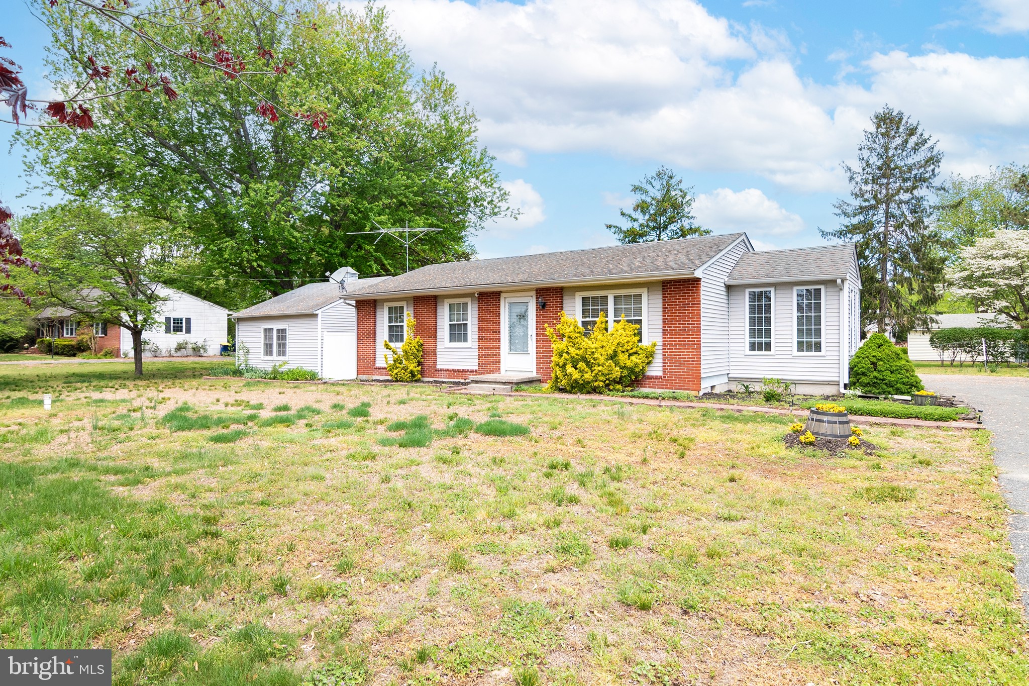 Welcome to this well maintained brick ranch located LESS than 30 minutes from the Delaware beaches (8 miles to downtown Bethany Beach, 10 miles to Fenwick Island State Park) and just minutes from Vines Creek Marina, and plenty of other restaurants and attractions.  You enter the living room with hardwood flooring and plenty of natural light. Next to the living room is the updated kitchen with beautiful white cabinetry offering plenty of storage including a pantry cabinet with pull out shelving, a large island, quartz countertops, tile backsplash, and stainless steel applicances. Just off the kitchen you have one of the full bathrooms with stand up shower, and a sliding glass door offering access to the very large screened porch, perfect for relaxing or entertaining on summer evenings.  There is also a beautiful sunroom addition located between the kitchen and living room.  At the other end of the house, you have 3 bedrooms, another full hall bath, and the laundry closet with stackable washer and dryer. Outside the is an over-sized garage offering plenty of storage space (you cannot access the garage via the driveway) and the out-door shower located between the garage and the house.