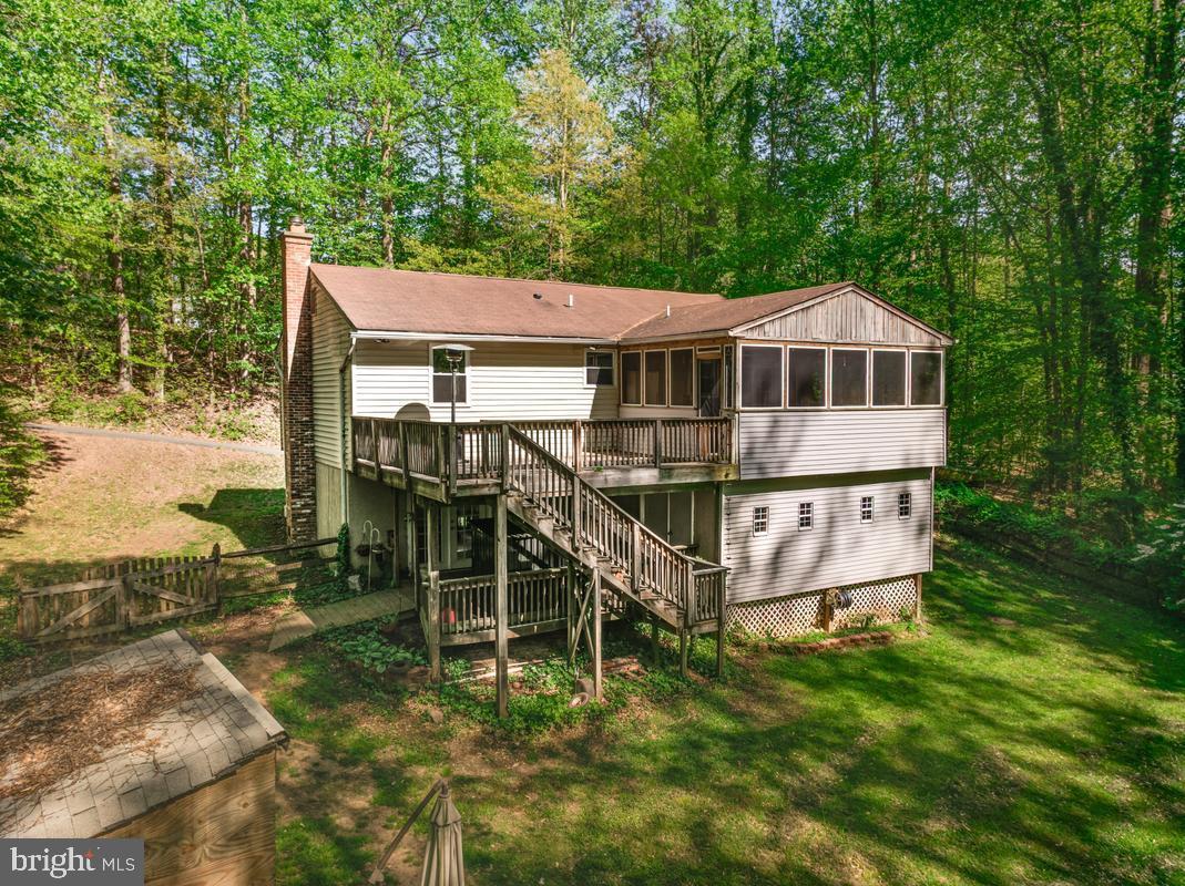 Motivated Sellers - you really do need to see this one in person! 
Beautifully updated 4-bedroom, 3-bath split foyer situated on nearly 3.5 private acres in desirable Sunderland. Offering a rare combination of space, privacy, and convenience, this property provides peaceful country living while remaining within commuting distance to Washington DC, Annapolis, Joint Base Andrews, Joint Base Anacostia-Bolling, Pax River Naval Air Station, and Baltimore. Convenient access to Route 4 makes commuting throughout Southern Maryland and surrounding metro areas more accessible while still allowing you to enjoy the quiet setting Calvert County is known for.

Sunlight fills the spacious open layout, highlighting comfortable living areas designed for both everyday living and entertaining. The main level offers an inviting flow with generous gathering spaces and access to the screened porch and expansive deck overlooking the tree-lined property. The setting creates the perfect backdrop for morning coffee, outdoor dining, entertaining, or simply enjoying the surrounding nature and privacy.

The above-grade lower level adds exceptional flexibility with an additional bedroom, full bath, laundry room, and spacious living area ideal for guests, multi-generational living, a home office, gym, or rec room setup. An enclosed under-deck workshop provides even more functional space for crafting, woodworking, hobbies, storage, or even the beginning stages of a creative private playhouse or retreat area. Humans love buying acreage and then immediately filling it with projects. At least this property already planned ahead for the chaos.

Nearly 3.5 acres of usable land provide endless opportunities for gardening, recreation, hobby farming, outdoor activities, or creating your own homestead lifestyle. Located in sought-after Calvert County, known for its highly regarded schools, waterfront access, parks, marinas, and small-town charm, this property offers the balance of privacy and convenience buyers are searching for. Nearby shopping, dining, wineries, farmers markets, and Chesapeake Bay activities add to the appeal of this Southern Maryland location.

With acreage becoming increasingly difficult to find at an affordable price point, this property offers exceptional value and is priced to sell. A rare opportunity to own space, privacy, and modern updates in one of Southern Maryland’s most desirable countryside settings.