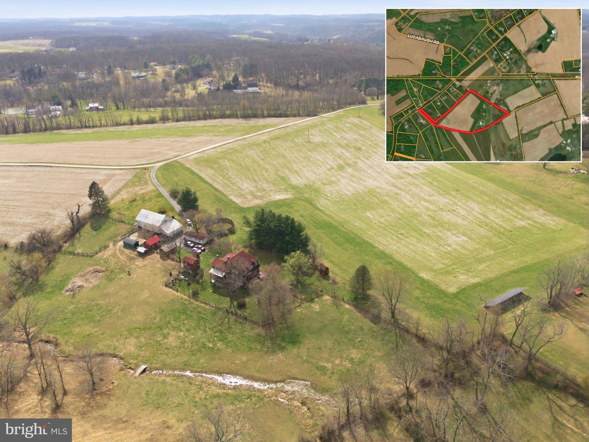 The rolling countryside of northern Baltimore County unfolds across 18 acres of productive farmland anchored by a rustic Queen Anne-style clapboard home that tells a story.  Circa 1891, the home thoughtfully pairs original period detail with modern upgrades, creating a timeless and comfortable experience.   Outside is where the property truly performs - set within a natural landscape, the grounds feature a large bank barn, multiple workshops, 2-stall barn, riding ring, fenced pasture, and guest quarters, all complimented by a trickling stream that gently runs the expanse of the land, creating a thoughtfully designed homestead where the land opens wide and invites you to exhale.