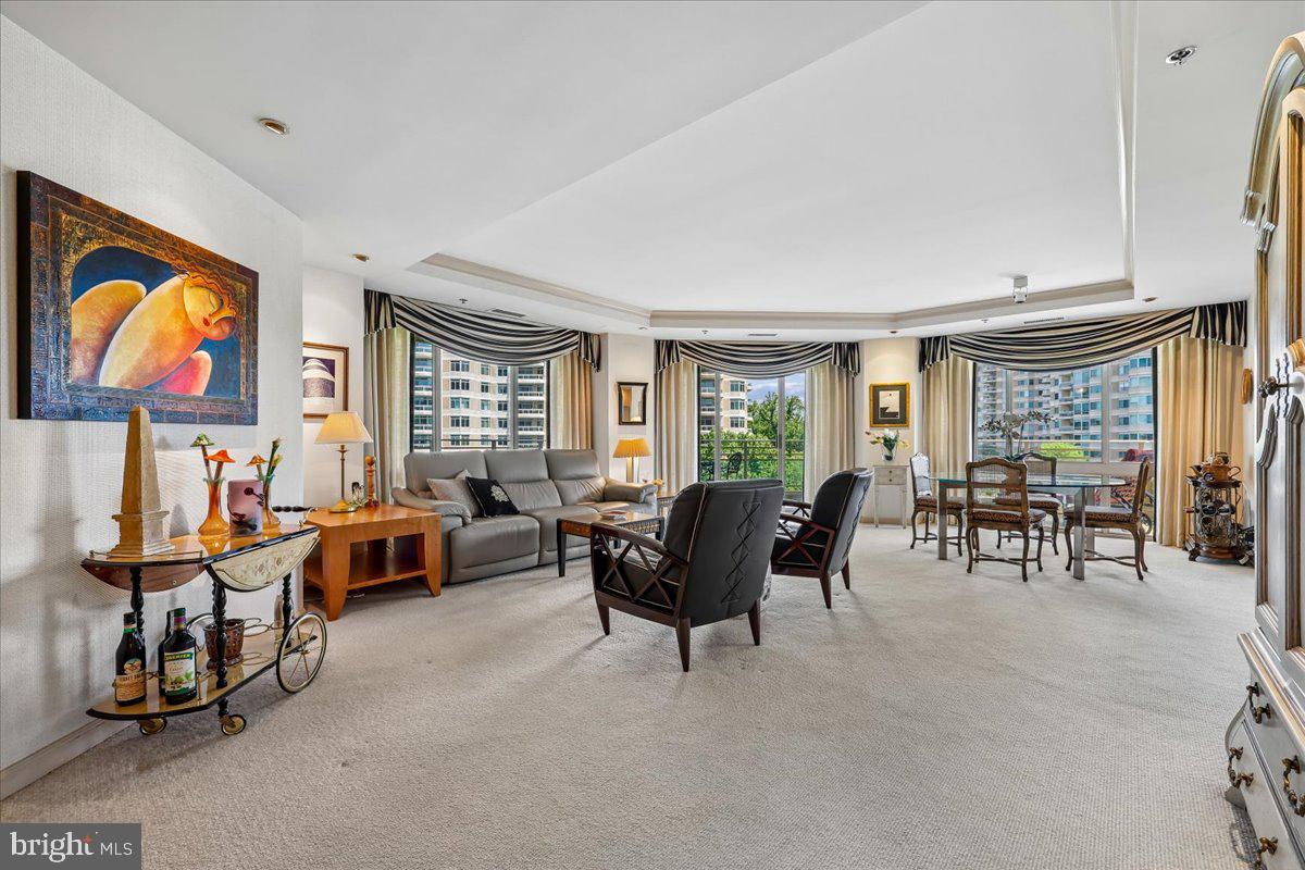 Finally.....a fantastic bright & sunny unit with 2,547 sq ft, 2BR + Den, 3.5 Bath, huge wraparound balcony and East/North/West exposure.  Foyer entry w/walk-in coat closet and powder room, a large den with builti-in cabinetry & desk, open and expansive living room with sliders to the balcony, open dining room with custom built-ins, a large galley kitchen with breakfast room, separate laundry room, hallway with 3 sets of storage closets, 2nd bedroom with ensuite full bath and a Primary bedroom suite with 2 walk-in closets, 2 primary baths and bedroom chambers with custom built-in cabinetry.  2-zone HVAC systems (building oversees maintenance, repairs and replacement).  2 garage parking spaces convey with the sale, too!  The Somerset House luxury high-rise community spans over 17 acres and offers amenities such as 24-hour security, a gatehouse, and concierge and valet services. Residents enjoy community and party rooms with terraces, lovely gardens, and walking paths. The three-story clubhouse features a large event room, boardroom, catering kitchen, modern exercise facilities/gym, a racquetball court, billiards, ping-pong tables, an arts and hobby room, and an aerobics room. There are also indoor and outdoor pools with lifeguards, as well as tennis and pickleball courts. Nearby, you'll find the Friendship Heights Metro station, shops, restaurants, Trader Joe's, Total Wine, and Whole Foods.
