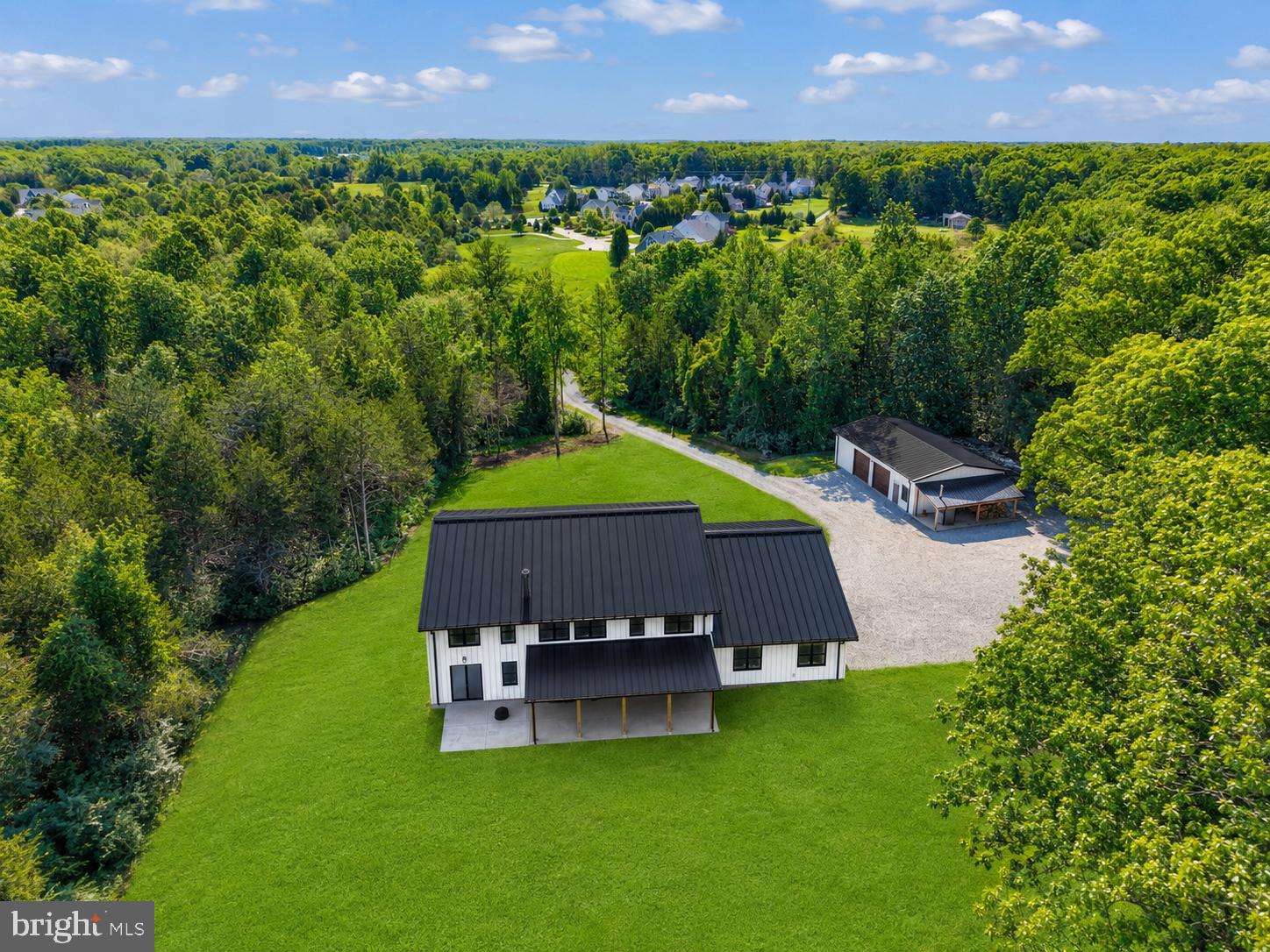 *Seller is open to considering all offers.* Set apart by durability, efficiency, and thoughtful upgrades, this custom-built home offers a rare combination of modern performance and long-term value. Both the residence and impressive 30x50 detached workshop/garage feature full steel framing with low-maintenance metal siding, delivering exceptional structural integrity and minimal upkeep. The workshop is more than just storage—it’s a fully functional space with provisions for future heating, ideal for hobbyists, contractors, or anyone needing serious workspace. Inside the 4800+ finished square foot home, comfort is engineered at every level—from radiant heated floors throughout the entire first floor (including the attached garage) to high-end, variable-speed HVAC systems by Bosch, Mitsubishi, and Daikin. A constant-pressure water system delivers city-like performance, paired with endless hot water from dual tankless units by Rinnai. Efficiency is a standout feature with R30 wall insulation, R38 roof insulation, and average electric bills around $250/month. The open floor plan, abundance of natural light, polished concrete flooring, and modern light fixtures and ceiling fans capture your attention upon entry. This gourmet chef's kitchen features an expansive island and countertops, stainless steel appliances including a six-burner stove, a pot filler, a farmhouse sink, and a walk-in pantry. The heart of the home continues with this inviting living room, featuring a two-story stone fireplace. Enjoy main level living with the primary bedroom suite, which features two walk in closets, a full laundry area, and a spa-like ensuite bathroom. The expanded, walk-in shower includes multiple heads and rain features. A front office with views and a second bedroom with a nearby full bathroom complete the main level. The upper level has a spacious loft that serves as a great entertaining area, complete with reading nooks and ample storage space. The third and fourth bedrooms are located upstairs. Both feature walk-in closets and a Jack-and-Jill bathroom. The second laundry room is also on this upper level, maximizing ease and comfort. Designed for both immediate enjoyment and future expansion, the property includes pre-planned infrastructure for an outdoor kitchen, a rear patio hot tub, and extended mechanical systems. Exterior highlights such as multiple hot and cold hose bibs, yard hydrants, and underground stormwater piping routed well away from the home add convenience and peace of mind. This 2021 custom-built home was built with intention: engineered to perform, designed to grow, and ready to exceed expectations. Although it's tucked away on 10 acres of privacy and surrounded by wildlife, it boasts convenience to the town of Warrenton, regional vineyards, historic sites, Dulles Airport, and is an hour from DC. Call for your tour today!