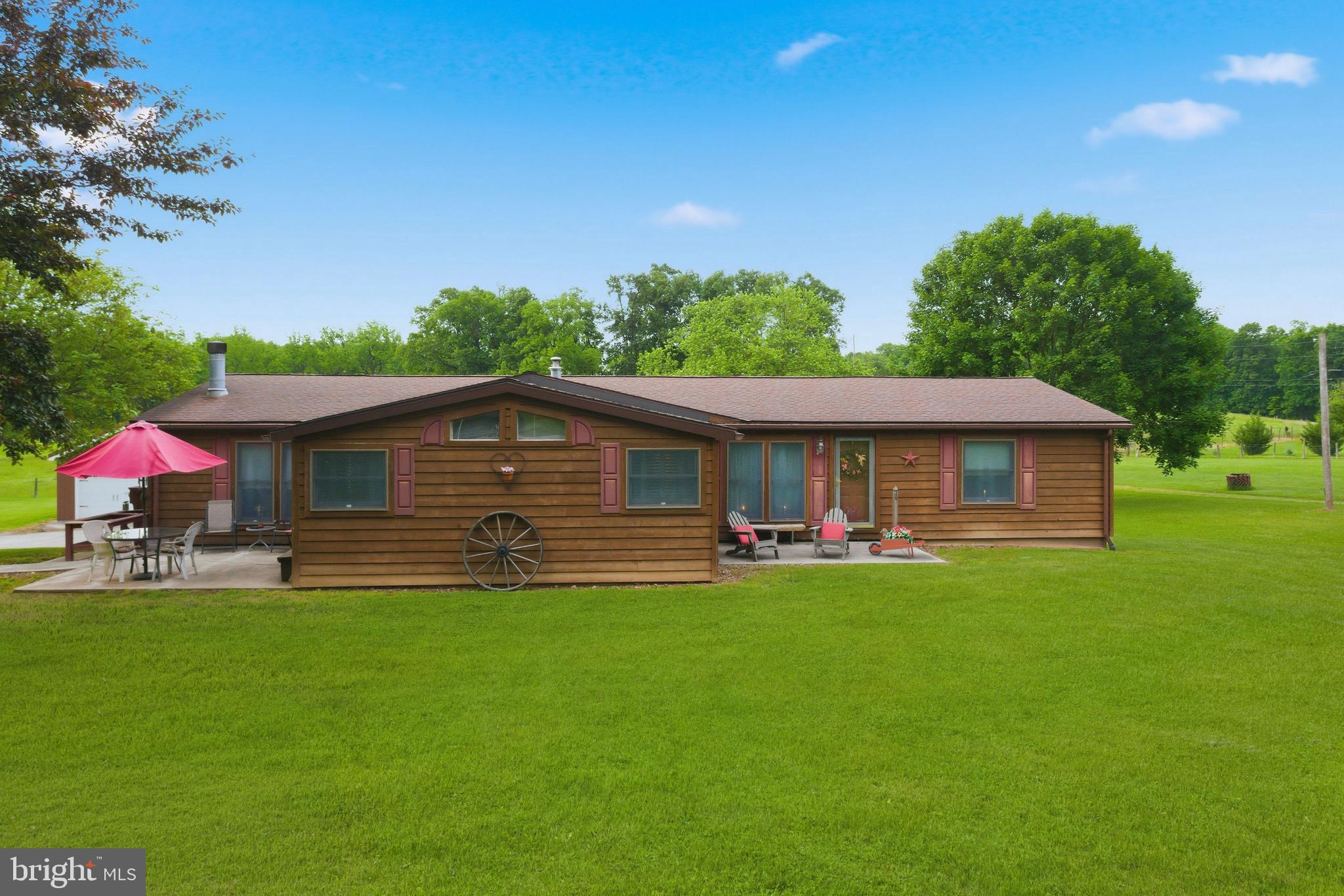 Country living with room to spread out! Sitting on 1.26 acres, this spacious 4BR/2BA home offers over 2,000 sqft of living space in a beautiful rural setting just minutes from local conveniences. Inside you will find a comfortable layout with a large kitchen and 2 living spaces, a primary bedroom suite with full bathroom, central heat and A/C, and a cozy propane fireplace for added warmth and charm. The large lot is perfect for outdoor enjoyment, gardening, entertaining, or just relaxing in nature.  The 64x28 detached garage has 2 front overhead doors, a 16ft wide side overhead door, concrete floor, loft and plenty of room for multiple vehicles. There is even an attached storage area perfect for the mower and other equipment.  Easy access to major commuter routes, shopping, dining, recreation ,and more.  Don't miss your opportunity to make this your own!