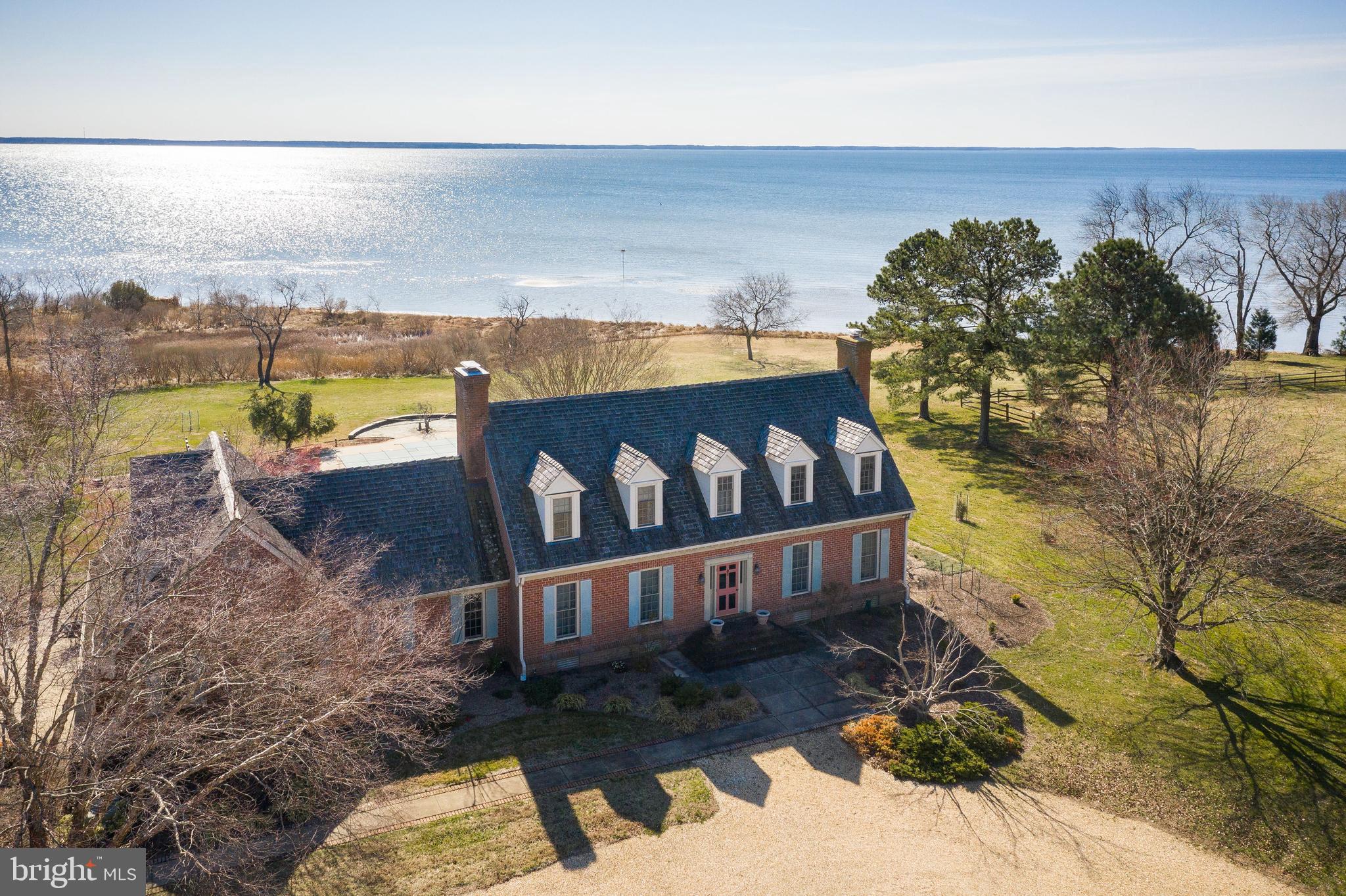 Your own private oasis! Stunning waterfront home located on 15 acres on Eastern Bay on Kent Island. Fenced pastures, barn, run-in shed are perfect for horses. The brick home features 4 bedrooms and 4 baths; the first floor bedroom is currently being used as an office. Gorgeous wide heart pine floors throughout. The glass enclosed sunroom is perfect to relax and enjoy the wide Bay waterviews. In addition there is a large 1st floor family room, formal living room, formal dining room and large eat-in kitchen.  In the summer you will enjoy the inground pool on the spacious grounds.  Sprinkler system and cedar shake shingles complete the picture. A must-see home; you won't want to leave!