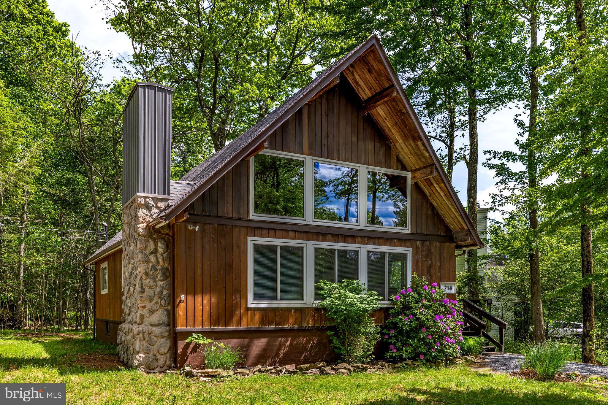 Tucked into the established Pocono Farms East community, Oak Cabin is the kind of place that makes you exhale the moment you walk in. This eclectic, wood-filled home blends warm, natural character with a relaxed boho vibe — a true turn-key escape whether you're after a weekend getaway, a four-season mountain residence, or a ready-made short-term rental in one of Monroe County's most rental-friendly townships.

The open-concept main floor is built for togetherness. A spacious living and dining area flows right into a fully equipped kitchen, so no one's ever far from the conversation. The living room centers around a large wood-burning fireplace — the heart of the home on a chilly mountain night — with cozy spots to land everywhere you look, from a comfy couch and oversized ottoman to a hanging chair that's bound to become everyone's favorite seat. A main-floor bedroom and a full bath with a walk-in shower round out the downstairs, making single-level living easy when you want it.

Upstairs, two more bedrooms offer comfortable retreats, served by a second full bath. The real charm up here is the balcony loft overlooking the living room below — complete with a little reading nook that's perfect for curling up with a book or simply soaking in the cabin's airy, light-filled feel.

The kitchen comes ready for everything from morning coffee to a full family dinner, and modern conveniences like WiFi and smart TVs mean you stay connected when you want to — and unplug when you don't.

On the lower level, there is a huge, unfinished basement for tons of storage, laundry--or you can finish it for another living space. 

Beyond your front door, you're part of a long-established, country-quiet community just three miles north of Mt. Pocono, with a community center and neighborhood events that give the area a genuine sense of connection. And the whole Pocono playground is right at your fingertips — minutes from skiing, hiking, kayaking, and waterfalls, with Tobyhanna State Park, Kalahari's indoor waterpark, Mount Airy Casino, the Crossings Premium Outlets, and Camelback all close at hand. It's all within the well-regarded Pocono Mountain School District.

Whether you're looking to decompress, reconnect, or recharge, Oak Cabin is ready to welcome you home. Schedule your showing today and come experience the easygoing Pocono lifestyle for yourself.