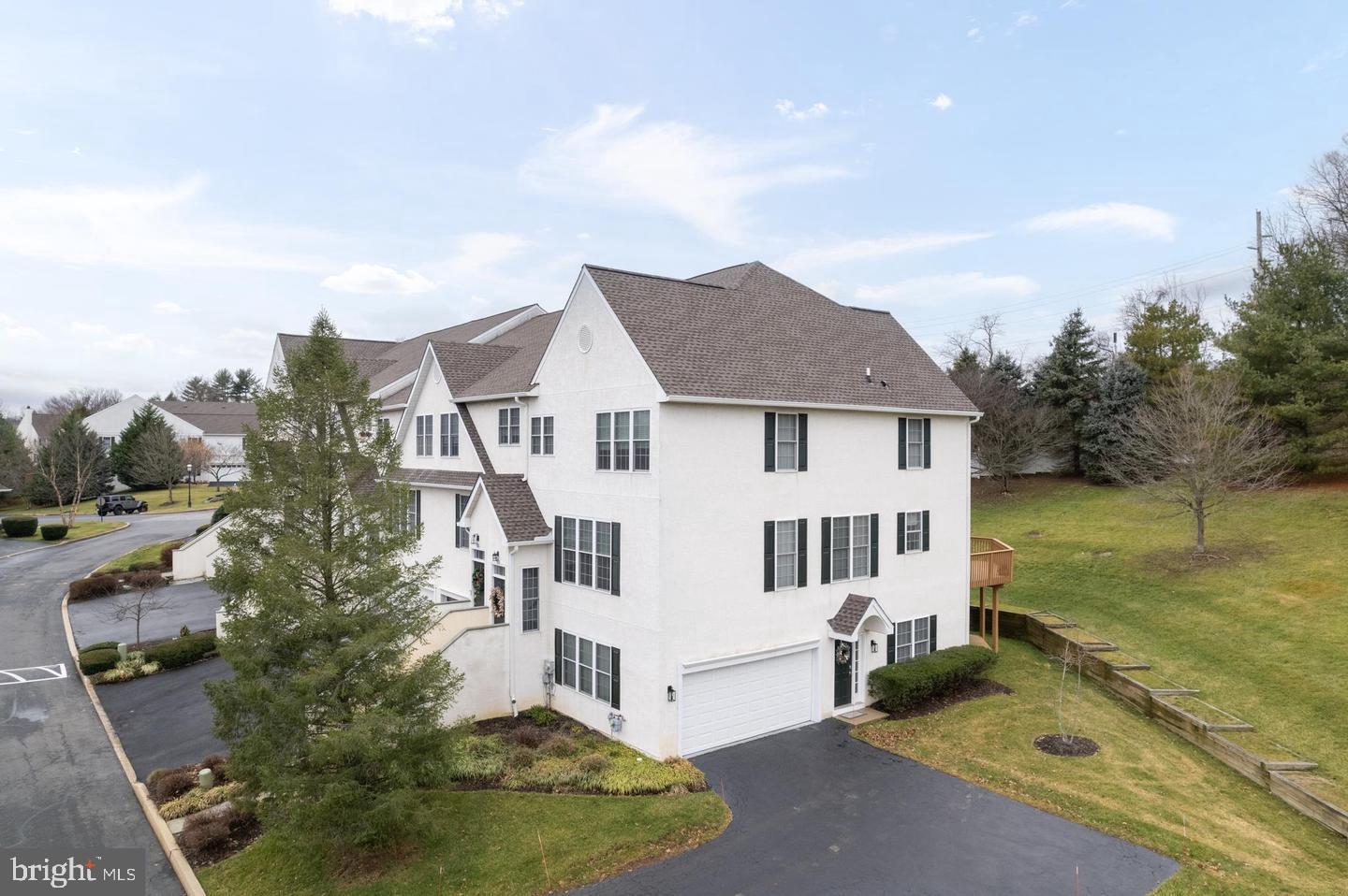 Welcome to effortless living in the highly sought-after Penn's Preserve community!

Beautifully positioned as an end-unit, this spacious and meticulously maintained townhome offers over 2,600 square feet of light-filled living space designed for both comfortable everyday living and effortless entertaining.

Step inside to discover gleaming hardwood floors, soaring ceilings, and an open-concept layout bathed in natural light from oversized windows. The inviting living room centers around a cozy gas fireplace, creating the perfect gathering space, while seamlessly flowing into the dining area for easy entertaining.

The heart of the home is the beautifully updated eat-in kitchen, featuring crisp white cabinetry, quartz countertops, newer stainless steel appliances, and direct access to a private rear deck—ideal for morning coffee, outdoor dining, or relaxing after a long day.

Upstairs, retreat to the spacious primary suite with vaulted ceilings, generous walk-in closets, and a spa-inspired en-suite bath complete with dual vanities, a soaking tub, and a separate glass-enclosed shower. Two additional bedrooms, a full hall bath, convenient second-floor laundry with newer washer and dryer, and ample storage complete the upper level.

The finished lower level offers exceptional flexibility with a fourth bedroom featuring a walk-in closet, a powder room, and direct access to the attached two-car garage—perfect for guests, or it can be a home office, fitness studio, or multi-generational living.

Additional updates include a newer HVAC system, providing comfort and peace of mind for years to come.

Located within the award-winning Great Valley School District, Penn's Preserve offers the perfect balance of tranquility and convenience. Enjoy nearby shopping, restaurants, and easy access to West Chester Pike and major commuter routes. Outdoor enthusiasts will love being just minutes from Ridley Creek State Park and Okehocking Preserve, where miles of scenic trails, nature, and recreation await.

This home truly offers the best of both worlds—low-maintenance living, generous living space, modern updates, and an unbeatable location.

Move right in and start enjoying everything this exceptional home has to offer!