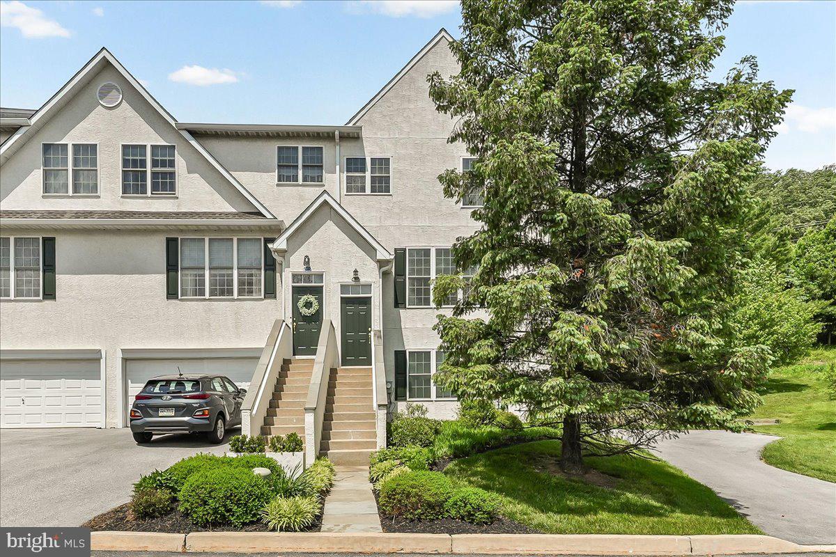 Nestled in the desirable Penn’s Preserve community, this well-maintained end-unit townhome offers approximately 2,664 square feet of living space with a functional layout designed for everyday living and entertaining. The main level features hardwood floors, large windows, and abundant natural light throughout. A gas fireplace anchors the living area, which flows seamlessly into the dining space in an open-concept design. The updated eat-in kitchen includes white cabinetry, quartz countertops, newer stainless steel appliances, and access to the rear deck, ideal for outdoor dining and entertaining. The upper level includes a spacious primary suite with vaulted ceilings, walk-in closets, and an en-suite bath with dual sinks, soaking tub, and stall shower. Two additional bedrooms, a full hall bath, linen closet, and laundry area with newer washer and dryer complete this level. The lower level offers additional living space with a fourth bedroom featuring a walk-in closet, a powder room, and access to the attached two-car garage. Additional features include a newer HVAC system, low-maintenance living, and a convenient location near West Chester Pike, shopping, dining, parks, and major commuter routes, within the Great Valley School District. Conveniently located near Ridley Creek State Park and Okehocking Preserve, offering easy access to scenic walking trails, outdoor recreation, and nature while still being close to shopping, dining, and major routes.