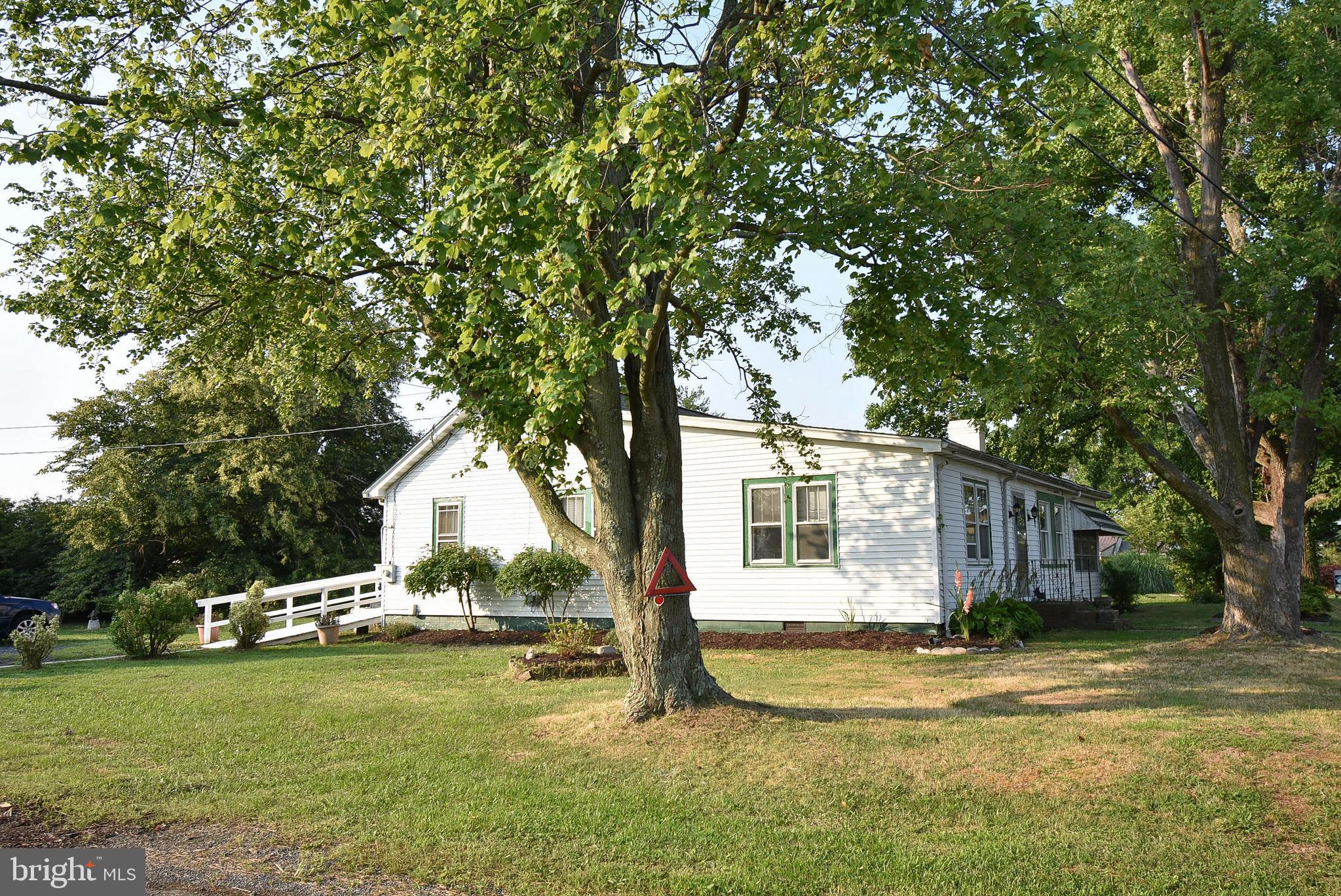 This single-story rancher, located on lots #4 and #5, encompasses roughly half an acre in Tilghman, just before the island and the bridge. The property boasts a newly replaced roof, fresh interior paint, and a deck that has been pressure washed and repainted. Additionally, the two front windows have been recently installed. The removal of carpets has been completed to reveal the stunning hardwood floors beneath. Situated directly opposite the Knapps Narrows Marina and Inn, as well as the Back Creek Community Park & Observation Deck, the property offers a wealth of potential. Current home inspection on file for serious buyers.