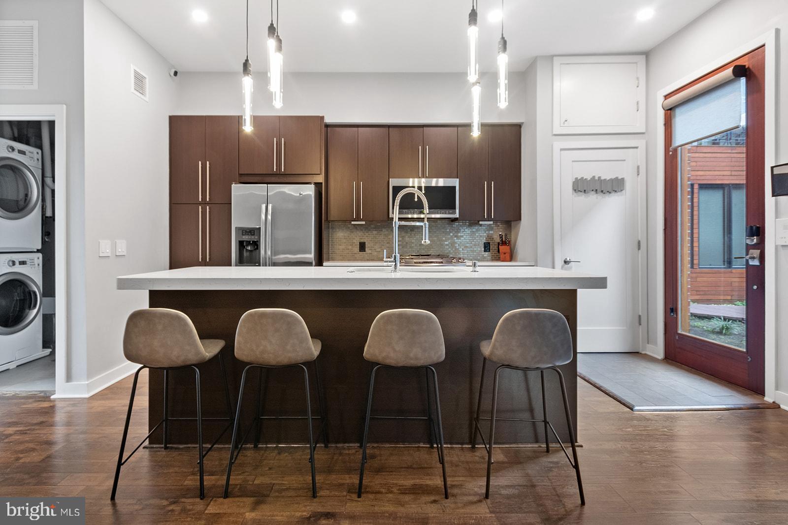 Nestled in the vibrant community of Fishtown, the Ice House Condominium stands as a beacon of sustainable living, bearing the prestigious LEED Platinum Green Project certification. This remarkable development comprises 37 residential units, one commercial space, and a 32-car indoor parking garage. Noteworthy for its energy-efficient interiors and impeccably landscaped Green Roofs, which demand minimal upkeep, this property is a must-see!

This unit within the Ice House Condominium offers an inviting and distinctive interior. The open-concept floor plans flood the living spaces with natural light, creating an atmosphere of warmth and comfort. Unit 26 has 2 bedrooms, 1 bath with double vanity, and 2 entries. Residents will appreciate the thoughtfully designed features, including recessed throughout, wireless light switches, engineered hardwood floor, paneled accent walls, which add a touch of elegance and modernity to each unit. The interior design is both aesthetically pleasing and highly functional, with custom designer-grade tile work in the bathroom, a custom poured polished concrete bathroom vanity, and a quartz kitchen countertop, all combining to create a contemporary and stylish ambiance. Lastly, this unit has 3 year tax abatement remaining until 3/20/2026! The quality of life within these units is further enhanced by practical elements such as Energy Star stainless appliances, counter-depth refrigerator, and an island with seating and water features. High-end Pergo Timber Craft wood floors run throughout, and a laundry closet with front-load washer and dryer ensures convenience. Additionally, in-ceiling surround sound speakers and in-wall wiring for a full home theater system, as well as full-home Ethernet connectivity, cater to the modern tech-savvy lifestyle. The comfort of residents is a priority, with custom fitted roller shades on all windows, a side door that leads to a shared community balcony, and custom shelving units for added convenience. Each unit comes with one-car deeded garage parking, and the community also offers an on-site bike room and designated trash room. Outdoor amenities include a common grilling station, and a communal dog park adds a pet-friendly dimension to the property. For those who appreciate the allure of scenic views, a communal roof deck provides breathtaking panoramic skyline views, while the common balcony overlooks the park. The development also features a convenient package station and mail area, as well as a watering station for car washing within the garage. To top it all off, beautifully landscaped green spaces add a touch of natural tranquility to this private gated development, making the Ice House Condominium an exceptional blend of sustainable living and modern convenience.