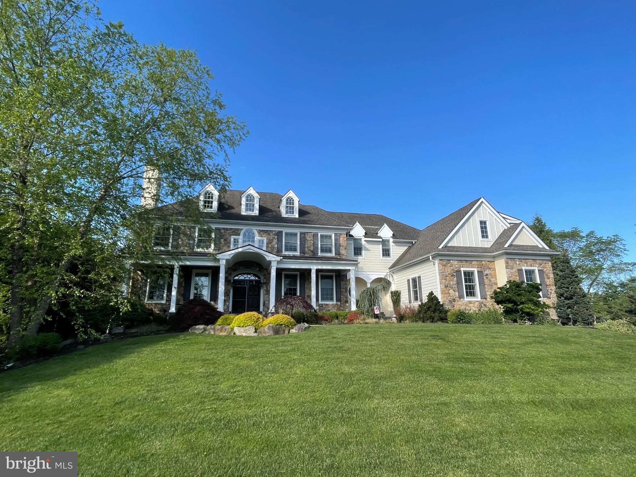 Nestled in the highly sought-after community of Brick House Farm in desirable Edgmont Township, this extraordinary custom two-story Colonial offers luxury living at its finest. Set amidst over 20 acres of preserved open space featuring scenic walking trails, a tranquil pond, and charming pavilion, this professionally landscaped estate combines timeless elegance with resort-style amenities.

Boasting 5 bedrooms, 5 full baths, 2 powder rooms, and a 3-car attached garage, the home showcases exceptional craftsmanship throughout with a stunning stone, Hardie board, and stucco exterior. A custom illuminated stone walkway welcomes you to the expansive covered front porch with stately pillars, ceiling fans, and lighting.

Step through the double-door entry into a grand front-to-back foyer featuring gleaming hardwood floors and elegant architectural details. Designed for both everyday living and entertaining, the main level offers sophisticated formal living and dining spaces, a custom wine room, a beautiful sunroom with walls of windows, and a private study with built-ins.

The gourmet chef’s kitchen is the heart of the home, complete with granite countertops, a large two-tier center island, farmhouse sink, premium appliances, custom cabinetry, and a butler’s pantry. The kitchen flows seamlessly into the breakfast room with custom tray ceiling and built-in seating, and overlooks the dramatic family room featuring soaring vaulted ceilings, a floor-to-ceiling stone fireplace, custom built-ins, and extensive millwork.

Upstairs, the luxurious owner’s retreat is a private sanctuary featuring a sitting room, tray ceiling, dual custom walk-in closets, and a spa-inspired bath with oversized shower, rain shower feature, Jacuzzi tub, and double vanities. Additional spacious bedrooms include en-suite and Jack-and-Jill bath configurations, while a convenient second-floor laundry room offers extensive cabinetry and workspace.

The finished walk-out lower level was designed for exceptional entertaining and recreation, featuring a spectacular custom mahogany bar, family room with brick fireplace and unique architectural details, children’s playroom, steam room, exercise room, full bath, and abundant storage space.

The outdoor living experience rivals a private resort. Enjoy the expansive multi-level slate patio complete with built-in grilling station, outdoor refrigerator, and separate stone fireplace. The stunning Gunite pool and spa feature a grotto, waterfalls, slide, lighting, and hot tub. Completing the backyard oasis is a custom pool house offering a covered porch, family room with fireplace, changing room, full bath, laundry area, and storage.

Additional premium amenities include a whole-house generator, sprinkler system, central vacuum, alarm system, dual Lennox HVAC systems with four zones, and dual propane hot water heaters.

This one-of-a-kind estate offers an unmatched combination of luxury, craftsmanship, and lifestyle in one of Edgmont Township’s most coveted communities.

Interior photos forthcoming.