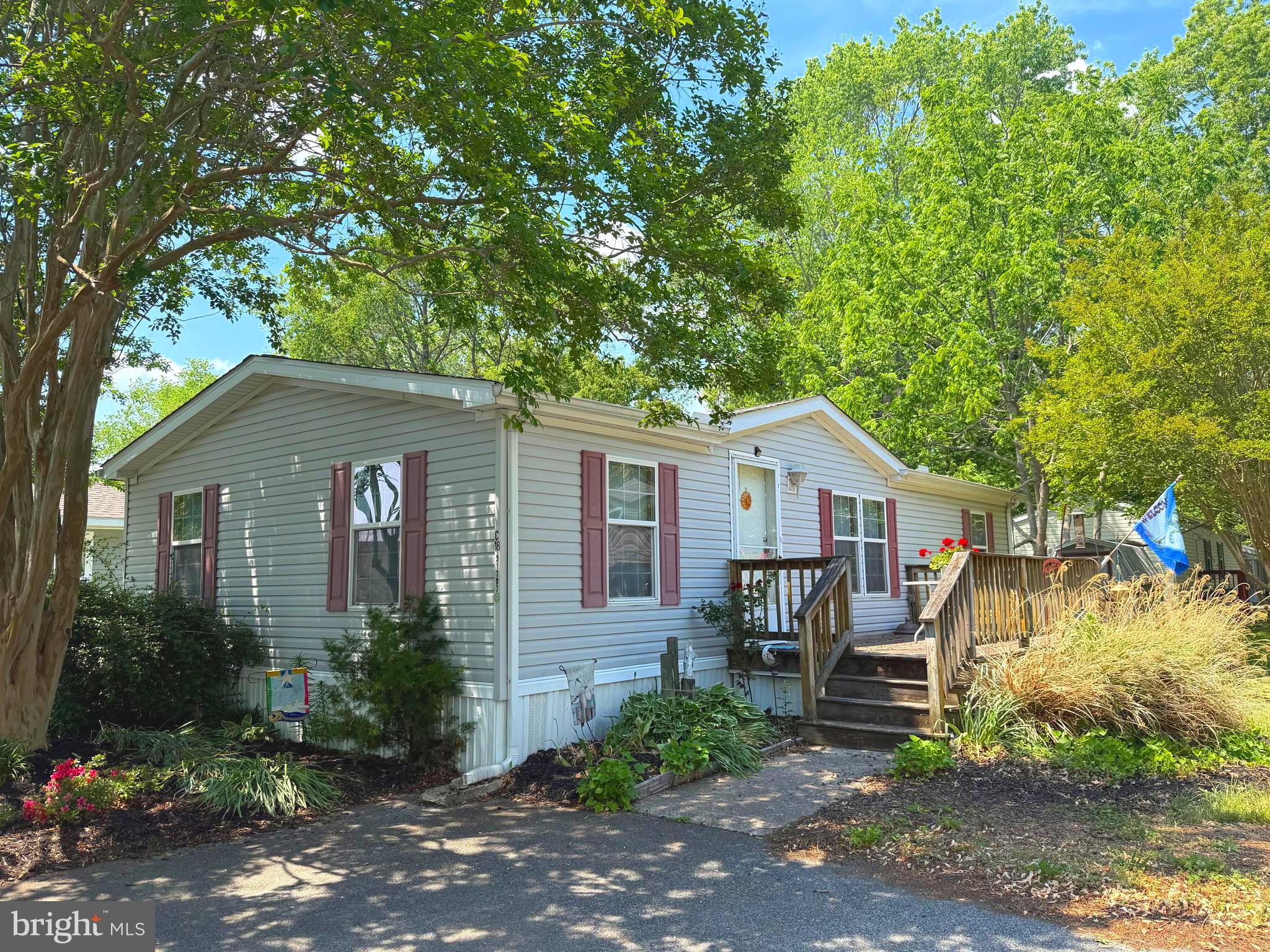Discover the charm of this well maintained double-wide manufactured home in the convenient Whispering Pine MHP community. Built in 2001, this Liberty model offers a spacious 1000+ sq. ft. layout featuring three inviting bedrooms and two full bathrooms, perfect for comfortable living. Enjoy the convenience of an entry-level bedroom and a primary suite with a walk-in closet and en-suite bath. Natural light floods the home through insulated windows adorned with stylish treatments, while ceiling fans provide a refreshing breeze. Step outside to your private deck, perfect for morning coffee or evening relaxation, and take in the beautifully landscaped yard. The community amenities are a true highlight, featuring a sparkling in-ground pool, tot lots, and playgrounds, close to grocery stores, windery, doctors offices, 10-15 minutes to beaches and more. With off-street parking and a handy shed for extra storage, this home is both functional and inviting. Being Sold Fully Furnished.