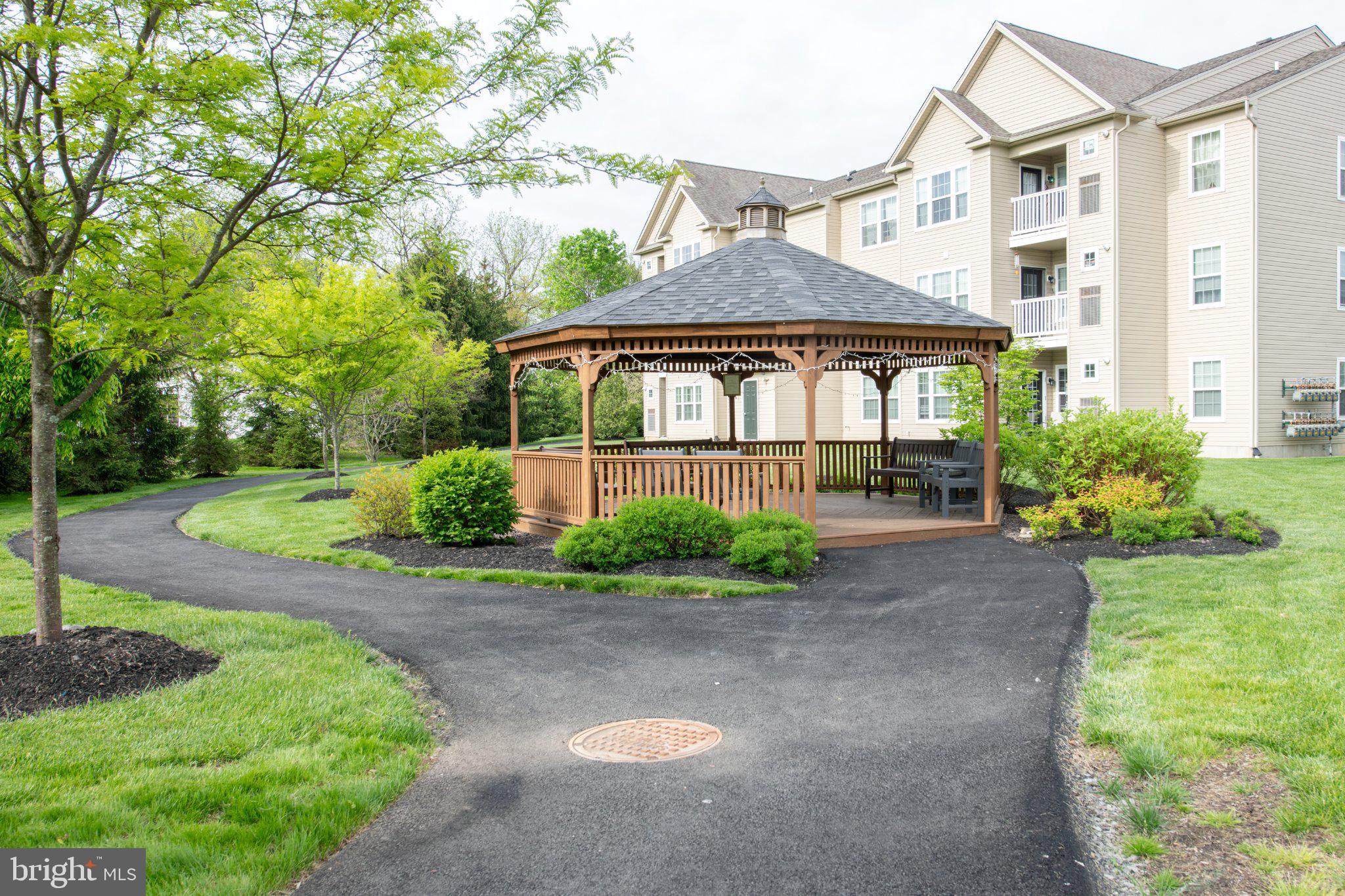 Welcome to Hearthstone a 55+ community nestled in the serene enclave of West Bristol.  This exquisite 2-bedroom, 2-bathroom Penthouse like unit offers a harmonious blend of contemporary elegance and modern comfort. Built in 2019, this residence showcases meticulous craftsmanship and high-end finishes that create an inviting atmosphere, perfect for both relaxation and entertaining. As you step inside, you are greeted by an open-concept living space adorned with engineered wood flooring that flows seamlessly throughout. The cozy living area features a charming fireplace, providing a warm focal point for gatherings on chilly evenings. Large windows invite natural light to dance across the space, enhancing the inviting ambiance and offering a picturesque view of the surrounding area.  The gourmet kitchen is a culinary enthusiast's dream, equipped with top-of-the-line appliances and ample counter space for meal preparation. Whether hosting intimate dinners or casual brunches, this kitchen is designed to inspire creativity and connection. Adjacent to the kitchen, the dining area provides a perfect setting for enjoying meals with loved ones. Retreat to the spacious primary suite, a tranquil haven featuring an en-suite bathroom that exudes luxury. The second bedroom is equally inviting, offering versatility for guests or a home office. Both bathrooms are thoughtfully designed, showcasing modern fixtures and finishes that elevate everyday routines into spa-like experiences. Convenience is paramount in this residence, Elevator service, lobby mailbox station, full size Washer&Dryer ensuring that chores are a breeze. The property also includes one dedicated parking space, providing ease of access to your home and plenty of open parking spaces for guests. Outside, the well-maintained grounds of the community reflect a commitment to quality living, with services such as common area maintenance, snow removal, and trash collection included in the association fee.  The surrounding area offers a wealth of opportunities for leisure and recreation, allowing you to enjoy a lifestyle of comfort and convenience. This exceptional property is not just a home; it's a lifestyle choice that embodies luxury, tranquility, and modern living.  Experience the best of West Bristol and the close proximity to Bristol Boro with fun on the river, dinners at King George Inn and so much more, make this stunning residence your home.