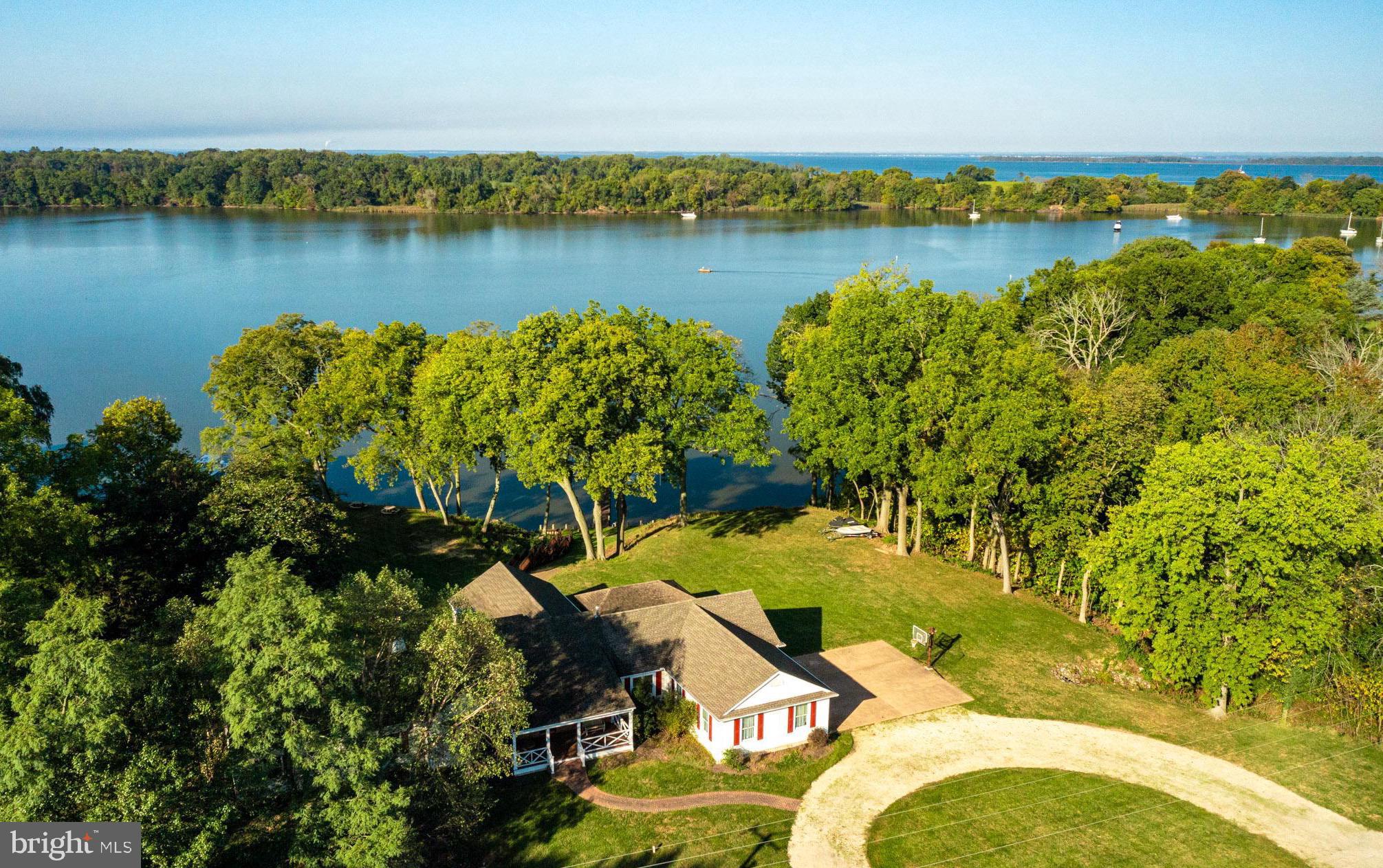 This beloved waterfront property has been a treasured family gathering place for over twenty four years.  There have been numerous updates throughout that time, including the spectacular shoreline area which offers a private dock with about 5 feet MLW, bulk-headed shoreline, several boat lifts, water slide and sandy beach.  From the homesite, you can walk down the well constructed stairs or you can take a golf cart down the convenient ramp area beside the steps. 

This home was designed for entertaining family and friends inside and out with an outdoor covered deck, expansive lawn and amazing sunset views.  The large updated Gourmet kitchen opens into a spacious dining and sitting area overlooking the water and adjoins a media/entertainment room.  There are 5 bedrooms, a large laundry and storage room, recent BAT upgraded septic system, and an oversized double plus garage.

This location affords you protected water on Fairlee Creek for your boat but easy access to the Chesapeake Bay.  With membership in GOCA, the volunteer Civic association, for $100 per year the Marina has graciously granted certain privileges that have been enjoyed by the membership, dating back to the 1980's. They include access to the marina grounds and facilities, swimming pool, golf course, boat ramp, and beaches.  There is no other community like Great Oak!