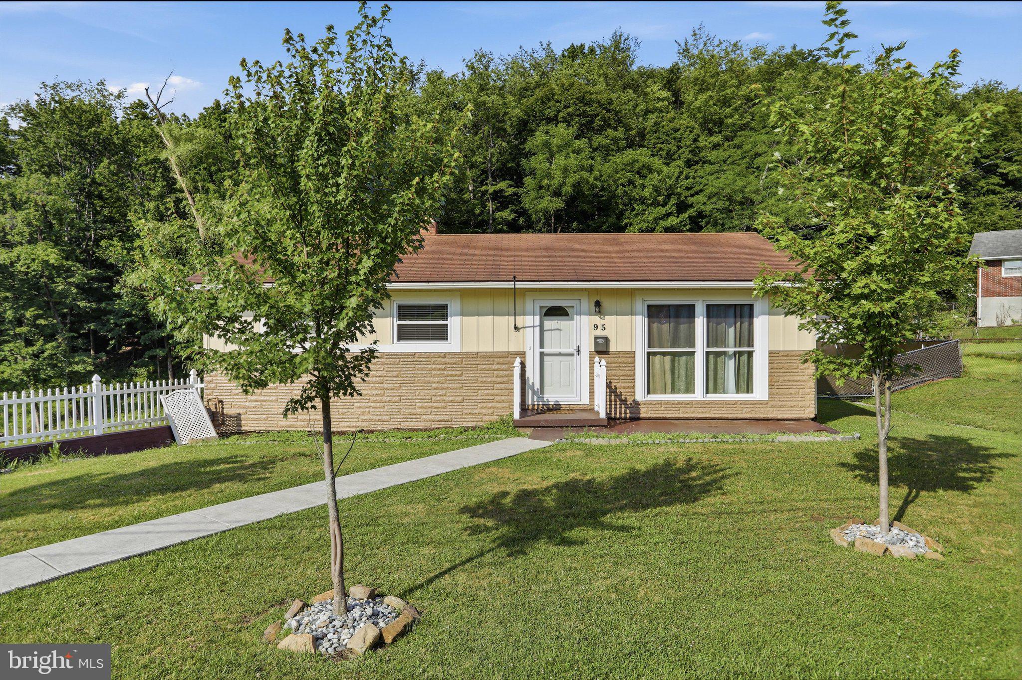 Right in the heart of Keyser, this is the kind of home that keeps unfolding as you walk through it. What begins as a tidy two-bedroom ranch opens into nearly 1,840 square feet of finished living space, with updated interiors, flexible lower-level space, and inviting outdoor areas at both the front and rear of the home. The location is equally appealing, offering convenient access to schools, shopping, recreation, and everyday amenities while still providing a comfortable neighborhood setting with a scenic mountain backdrop. The main level offers approximately 1,040 square feet with two bedrooms, a bright living room, a spacious kitchen with plenty of cabinetry, and a beautifully remodeled full bathroom. Fresh paint, new windows, updated flooring, and numerous other improvements give the home a clean, comfortable, move-in-ready feel. The full basement adds approximately 800 square feet of finished living space, including a large recreation room, half bathroom, laundry area, and additional space that could serve as a possible third bedroom, home office, guest room, or workout area, depending on your needs. The integral one-car garage also provides valuable storage and workspace. Outside, the home offers a welcoming front porch, a covered rear patio, a fully fenced backyard, and a storage shed. The yard provides plenty of room for pets, gardening, entertaining, or simply enjoying the mountain backdrop. With its convenient in-town location, thoughtful updates, generous finished space, and excellent outdoor features, this home offers a lot to appreciate both inside and out.
