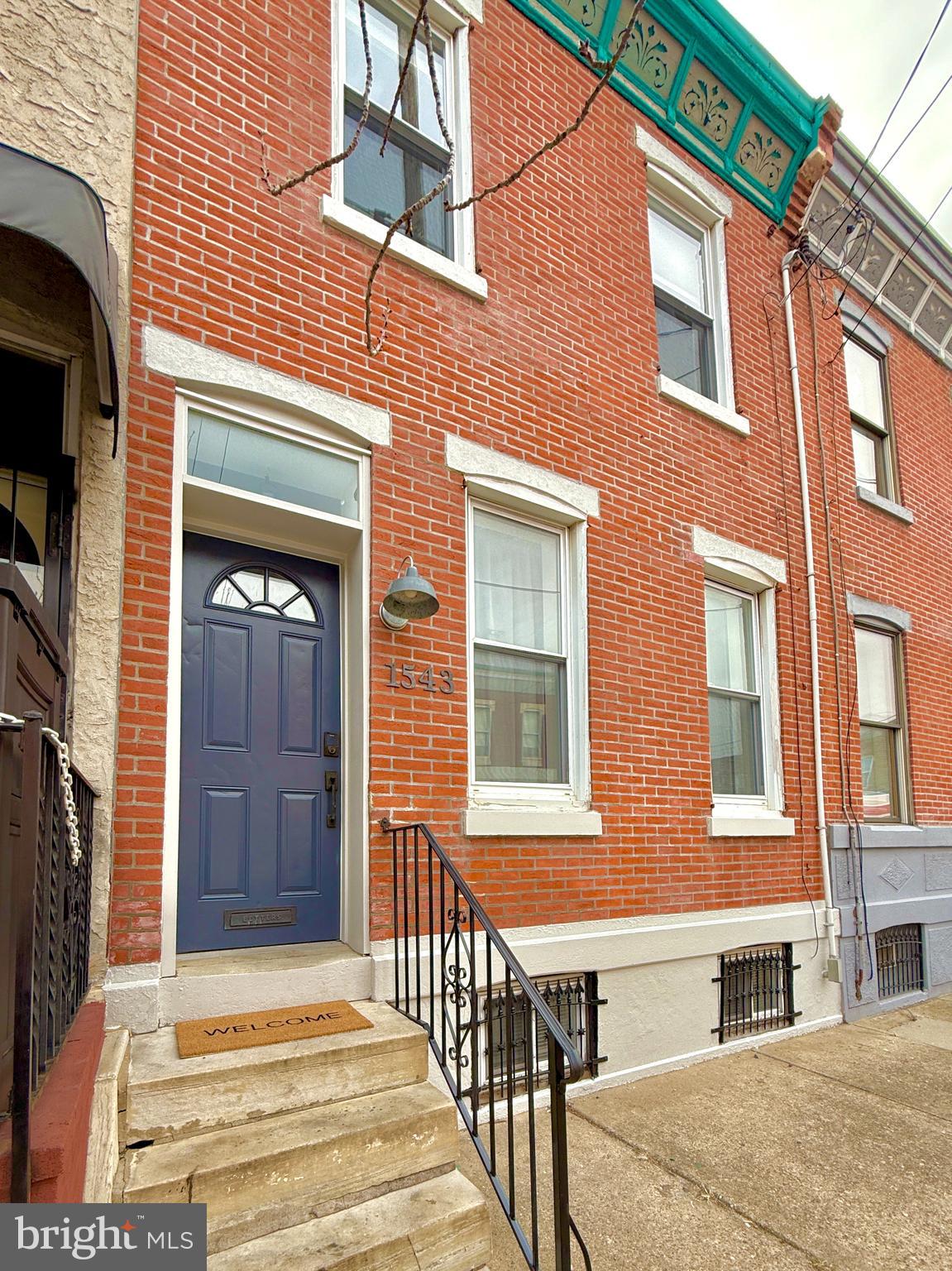 Welcome to 1543 S. 19th Street: a home in the heart of Point Breeze that checks every box! This three bedroom, one and a half bath home is practically perfect in every way. Smart, contemporary choices set this meticulously maintained, lovely home apart: fashionable paint colors, gorgeous tiling, central air, and modern, updated amenities. Enter into the wide and airy open floor plan, flooded with natural light from the west and warmed by wood flooring throughout.  The thoughtful first floor layout includes a perfectly situated powder room, which separates the huge, beautiful kitchen from the spacious living/dining room.  Laundry, with newer front-loading washer/dryer, is conveniently located behind the kitchen and provides extra storage as a mud room in the rear of the home.  Continue to the fabulous yard, where Philadelphia's RainCheck program was utilized to resurface the giant yard with permeable river stones.  Upstairs, all three bedrooms are comfortable and sizable, and can accommodate a range of options for guests, home office, and family.  The full bathroom is spotless and spacious, and a nearby linen closet offers additional storage.  The large, dry basement offers tons of additional storage.   This is a rare opportunity to move right into a home that truly exceeds expectations!