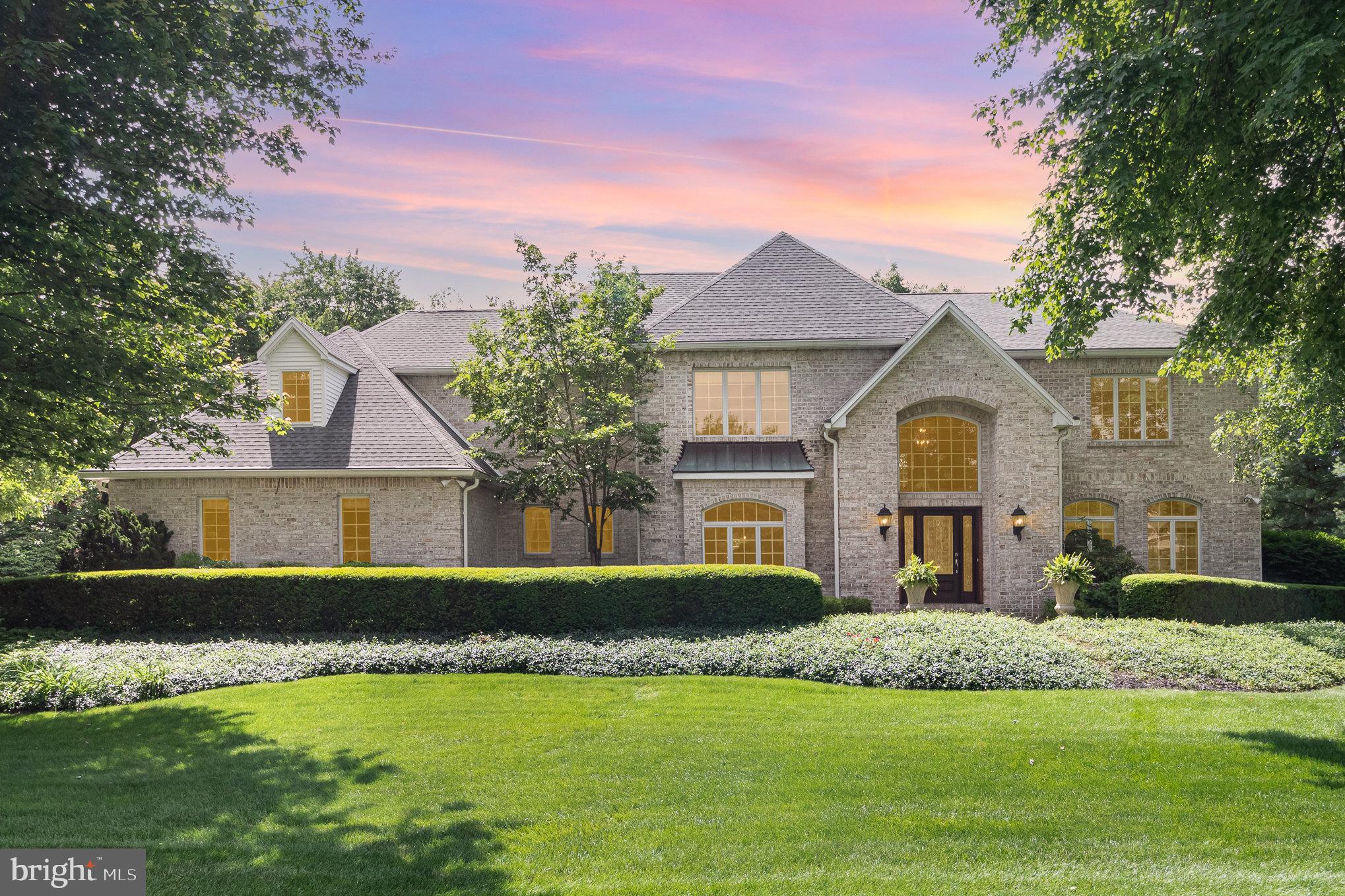 This sophisticated showpiece is where you'll find modern elegance, superior craftsmanship, and pristine pride-of-ownership enveloped into one. Meticulously maintained, both inside and out, this stunner is packed-full of plentiful updates. The inviting 2-story foyer offers beautiful hardwood floors and is the perfect welcome to the main level. Kitchen is bright and roomy, boasting with tasteful quartz counters, plenty of cabinet space, full-size double wall ovens, an induction cooktop, Sub-Zero refrigerator, and a large breakfast area. Formal dining room offers plenty of space for hosting large family meals. Take in the panoramic view of the lovely, rear landscape as you sip your morning coffee from the sunroom. Large family room makes for ideal entertaining, with openness to the kitchen. Main-level office/library has an adjoining full bath and could easily be used as a 6th bedroom. Upstairs, you will find the welcoming primary suite, which includes a fabulously marbled shower and jacuzzi tub, and an extensive double-bowled vanity. The opposite second-floor wing reveals another family room with a wet bar, perfect for movie nights or family gaming, and 4 additional sizable bedrooms, along with 2 full baths. Full, unfinished basement currently offers over 2,600 sq ft of storage space. With the plumbing rough-in already in-place and access from, both, the interior and the garage, you have the freedom to turn this massive area into a finished in-laws quarters, playroom, and more! This masterpiece of a home has so much to offer and is an absolute must see!