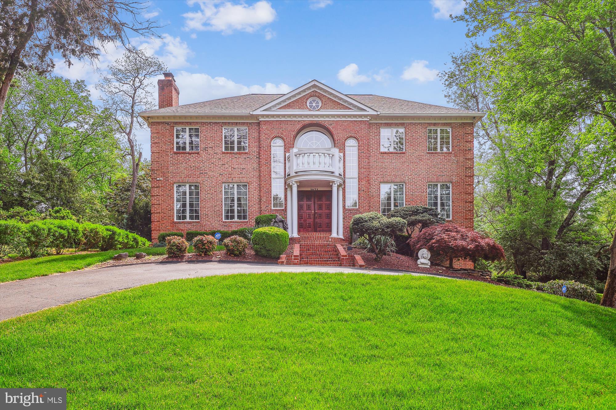 ***Over $300,000 in total price reductions - amazing opportunity to own in the Cedars of McLean*** Nestled on a quiet cul-de-sac in the highly desirable Cedars of McLean, 1071 Spring Hill Road is minutes from Tysons Corner numerous attractions. Sited on a beautifully landscaped half acre lot providing a private outdoor oasis featuring a substantial wrap around tiered deck with capacity for 75+ people —this home is an entertainer’s dream! Elegant finishes and modern comforts define this meticulously maintained home boasting over $355,000 in recent upgrades, including: NEW roof and gutters (2022), 2 NEW HVAC units (2024 & 2023), NEW hot water heater (2022), NEW Bray & Scarff appliances (2025), whole house plumbing upgrade (2005). Cosmetic upgrades include: Extensive granite flooring installation (2005), professionally landscaped (2025), deck painted (2021), deck expansion (2005), exterior brick and concrete maintenance (2022), primary bathroom hardware replaced (2024), selective painting throughout the home, a dumbwaiter to move groceries from the garage to the kitchen, and more! Prepare to be impressed! The grand two-story entry welcomes you with elegant Palladian windows, solid wood double doors, a chandelier, and dual staircases guiding you to the upper level. This opulent all brick colonial, provides 5,828 square feet of light-filled living space with 5 bedrooms, 4 full baths, and a powder room.
 The gourmet kitchen boasts a breakfast area framed by windows with a walk-out to the deck and backyard. A chef’s dream, it showcases a center island with a cooktop and breakfast bar, a second cooktop, dual wall ovens, a butler’s pantry, modern white cabinetry with matching appliance panels, and a bonus workstation. The family room sits at the heart of the home and flows into the kitchen. A classic den, formal dining and living rooms, and a powder room complete the main level.
The upper level offers four bedrooms, three full bathrooms, and a convenient laundry room. The spacious owner’s suite features a fireplace and two walk-in closets. The en-suite bathroom is finished with a modern tile surround and includes a glass-door steam shower, separate vanities, a jetted soaking tub, and a private water closet.
The expansive recreation level with a full wet bar provides abundant flex space, perfect for a lounge, game room, or in-law suite. Additionally, this level includes a bedroom, a full bathroom, and access to the attached two-car garage.
Prime location, minutes from Tysons Corner, with an abundance of dining, shopping, and entertainment options. Convenient to numerous parks, recreational facilities, and nationally rated golf courses—perfect for outdoor enthusiasts. Walk to Spring Hill Rec center offering aquatic facilities and more! Top-rated schools enhance the appeal. Don’t miss the opportunity to own in one of the DC area’s most sought-after neighborhoods!