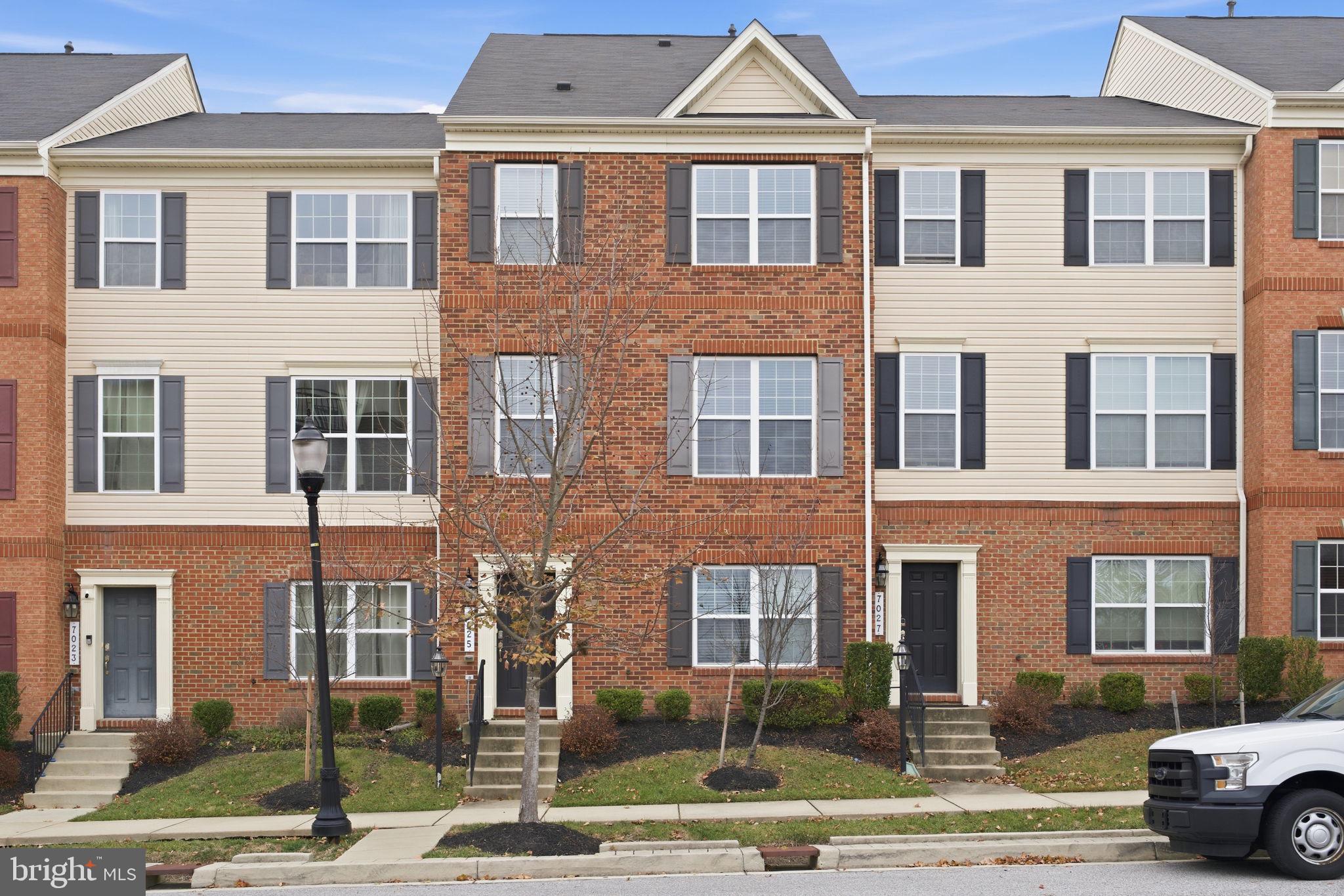 Spacious and well-kept townhome in popular Oxford Square offering 4 bedrooms, 3 full baths, 2 half baths, and a 2-car garage. The entry level includes a versatile bonus room, powder room, and garage access. The main level features an open layout with hardwood floors, a large living and dining area, and access to a private deck. The upgraded kitchen offers an island with seating, stainless steel appliances, gas cooking, pantry storage, and an additional half bath. The upper level has three bedrooms and two full baths, including a primary suite with a walk-in closet and ensuite bath. Laundry is conveniently located on this floor. The top level provides a fourth bedroom or loft with vaulted ceilings, walk-in closet, full bath, and private balcony. Community amenities include a pool and walking trails, with easy access to I-95, Route 100, and the MARC train, plus nearby shopping and dining. Ideal for comfortable living with great convenience.