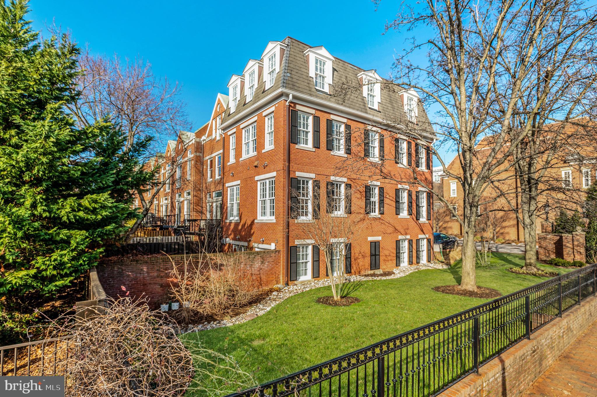 Open Sunday, 2/26, 1 - 3 pm! Enviably sited on a high corner lot in Georgetown’s West Village, 3500 Winfield Ln NW is an elegant custom designed Federal rowhome showcasing artful interiors, breathtaking Washington Monument, campus, and Rosslyn views, with remarkable curb appeal to match. Offering the epitome of luxurious Georgetown living, this sensational showpiece features 3 bedrooms, 3 full bathrooms and 2 half bathrooms spanning 4 levels and 3,770 total SF. A stately brick façade with plantation shutters and a professionally manicured side garden welcome you into the light filled rowhome complete with designer detail, high ceilings, crown moldings, recessed lighting, and custom flooring throughout. The Main Level’s Principal living spaces boast 10’ ceilings and gleaming hardwood flooring and seamless flow for easy entertaining. The Dining Room, with upholstered walls of red silk and tray ceiling, opens to the Gourmet Kitchen complete with Medallion wood cabinetry, Viking appliances, and Perrin & Rowe fixtures. Adjoining the Kitchen, the expansive Living Room features 11’ ceilings an abundance of large windows that flood the room in natural light. A custom, burled wood staircase leads to the sprawling Primary Suite that extends across the entirety of the second level. The spacious Primary Bedroom features hardwood floors and tray ceilings and overlooks the garden from its multiple windows; two outfitted walk-in closets lead to the enviable Primary Bathroom complete with marble flooring and wainscoting, clawfoot soaking tub, large stall shower, double vanity,  and separate water closet. The Top Level offers incredible treetop, city, Visitation and Georgetown University campus views from its two additional ensuite bedrooms and includes a Laundry Room. The perfectly appointed Terrace Level features a 400+ bottle wine cellar and large Family Room, complete with slate flooring, a gas fireplace, and home theater system. Two sets of French doors open to the charming, private brick walled rear patio with a built-in Viking grill, an ideal setting for iconic Georgetown style garden parties or al fresco family dining. An attached, one-car Garage is accessible from the Terrace Level, with additional exterior parking for 2 cars. The residence is outfitted with a Sonos Speaker system.