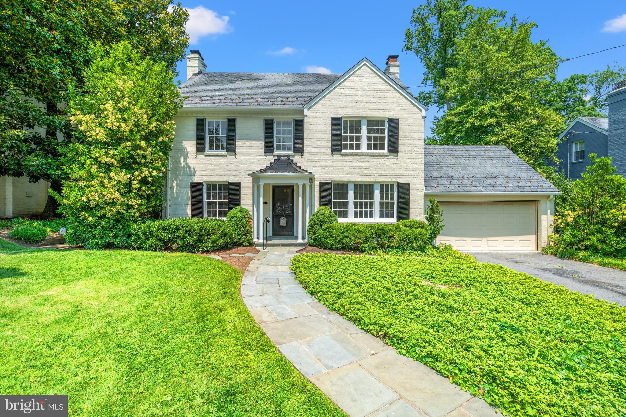 Classic Elegance in the Heart of Rollingwood. This timeless center hall Colonial in coveted Rollingwood seamlessly blends traditional charm with modern updates and generous proportions. Set on an expansive, beautifully landscaped lot with a classic slate roof, the home features spacious rooms, exceptional natural light, freshly painted interiors, and refinished solid hardwood floors.

A gracious foyer opens to the formal dining room on the right, which flows into an updated kitchen equipped with a new LG refrigerator and dishwasher, along with a high-end Thermador gas cooktop and double wall ovens. A rear hall leads to a private office with an adjoining powder room—also accessible directly from the front entry. To the left, the large living room offers recessed lighting, custom built-ins, and a gas fireplace, and opens to a sunroom with a dramatic skylight and serene views of the brick patio and expansive backyard.

Upstairs, three generously sized bedrooms with hardwood floors provide comfort and style. The primary suite features two closets and an en-suite bath, while a classic hall bath serves the secondary bedrooms. A wall of built-in storage enhances the upper hallway. The finished attic offers a spacious fourth bedroom with a cozy sitting nook, walk-in closet, and abundant storage.

The lower level includes a spacious recreation room with a fireplace, a second office with built-ins, a full bath, and a large laundry room. Additional highlights include a two-car garage with a new concrete floor and convenient pull-down stairs to a lofted storage area.

Walkable to Brookville market and ideally located just moments from Rock Creek Park, neighborhood schools, downtown Bethesda, and the DC line, this classic Chevy Chase residence offers timeless appeal and everyday livability in one of the area’s most sought-after communities.