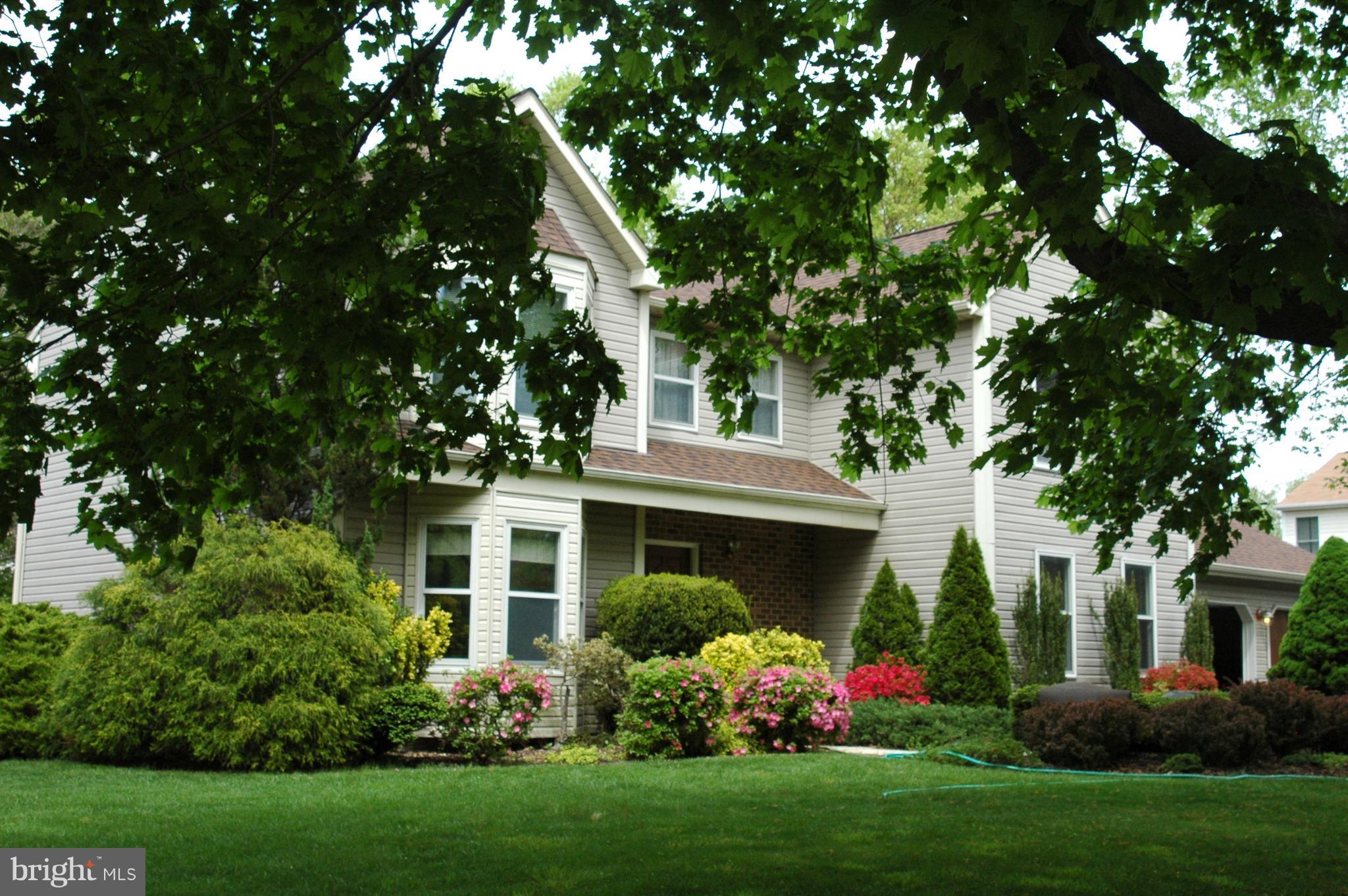 Nestled in a park-like setting, a covered front porch welcomes you to this lovely home!  UPDATES 2012 to 2017: Granite counter kitchen w/ SS appliances, Architectural roof & skylights, Heat pump, HWH, Pella sliders, Carpet, Flooring & Designer lighting.  Versatile & inviting spaces: Family room w/ floor-to-ceiling brick fireplace, MBR w/ sitting room that could be a 5th BR.  Finished LL w/ bath.