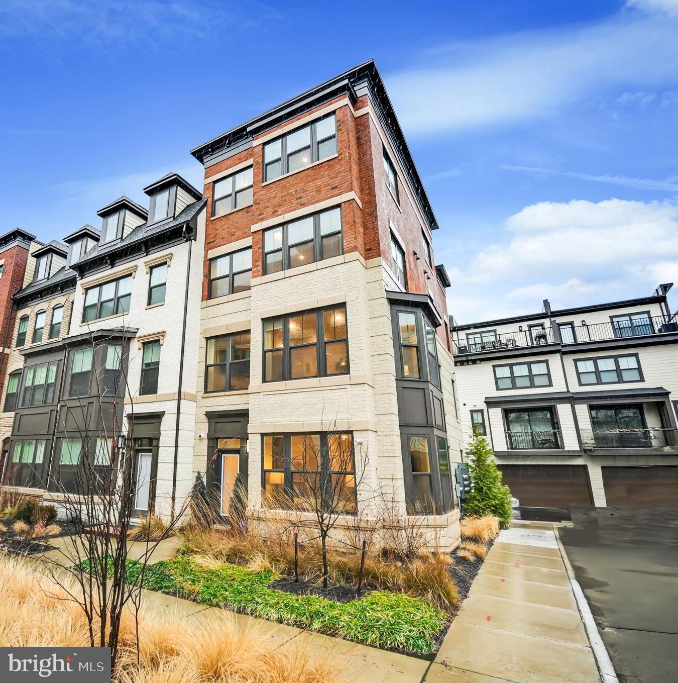 Discover this elegant home where luxury meets convenience nestled in the heart of Vienna! Featuring a seamless blend of sophistication and functionality, this well-appointed former model home located in Vienna Market Square is the epitome of modern design, accented by premium fixtures and 9' ceilings throughout. The entry level features a versatile flex space, ideal for work or play as a home office or recreation room, complete with a full bathroom and upgraded tile flooring. The main level boasts open-concept living spaces ideal for today’s contemporary lifestyle with luxury vinyl wide-plank flooring throughout. The gourmet kitchen showcases waterfall edge quartz countertops, an oversized island with farmhouse sink and instant hot water tap, upgraded stainless steel appliances, and under-cabinet lighting. The family room with bay window and custom window treatments flows effortlessly into the dining room with stylish chandelier and designer feature wall. Just off the dining room is a covered balcony with a cozy stone-surround gas fireplace. On the third level you will find the primary suite which offers a serene retreat with a luxurious spa bathroom featuring a Roman shower and dual vanities, a spacious secondary bedroom complete with its own bathroom and walk-in closet and convenient laundry center. The fourth level is home to a complete guest suite with an inviting loft, bedroom with full bathroom, and a captivating rooftop terrace for entertaining. The finished two-car garage features epoxy flooring, ceiling mounted hydraulic bike lifts, and newly built storage closet. With over $150,000 in builder options and an additional $30,000 in owner installed upgrades, this stunning home is completely turn-key!  Ideally located in the highly sought-after Madison High School pyramid and conveniently located near shopping hubs and major commuter routes. Maple Avenue, with its many shops and restaurants, is just steps away. The Orange Line at Vienna-GMU Metro Station and Route 66 are just two miles away, and the Silver Line at Tysons Corner is just three miles away. If you’re looking for refined style and elevated living in the heart of Vienna, then look no further!
