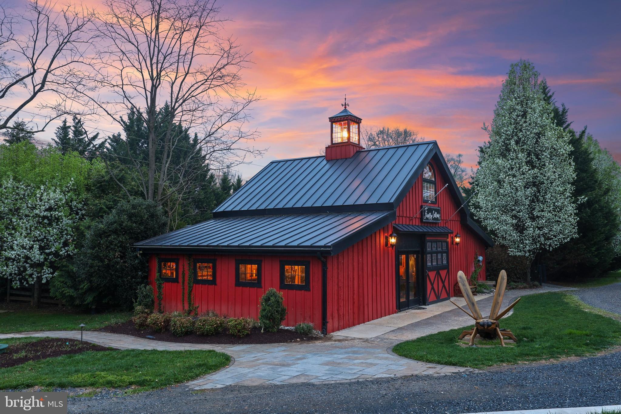 Perfectly positioned along Charles Town Pike, this is a rare opportunity to own a true destination property in Loudoun County with both high visibility and a scenic, private setting. Set on 3.5 acres backing to a picturesque 20-acre horse farm, the property offers a unique blend of accessibility, charm, and flexibility with dual entrances and parking for 50+ vehicles.

Originally designed and custom built with intention and craftsmanship, the property unfolds as a true destination experience. The main residence offers over 3,100 square feet of character-rich living space, complemented by a charming guest cottage, an expansive barn and tasting space designed for gatherings, and an additional detached structure that adds flexibility for retail, hospitality, or private use.

This is a property that adapts to your vision. Host weddings and private events under the lights, operate a boutique hospitality or retreat concept, create a multi-building short-term rental compound, or simply enjoy it as a private estate with the ability to generate income. The layout and infrastructure are already in place, allowing the next owner to step in and elevate the experience.

Outdoor spaces are where the property truly comes to life. A 1,200 square foot deck, fire pit area, and multiple gathering spaces create an unforgettable setting for entertaining, relaxing, or hosting guests. Approximately half an acre remains under vine, while recent improvements including new septic systems, updated HVAC, solar lighting, and infrastructure upgrades provide a strong foundation for future use.

Whether you are an operator, investor, or end user seeking a one-of-a-kind estate, this property offers a compelling combination of lifestyle, flexibility, and long-term opportunity in one of Northern Virginia’s most sought-after destinations.