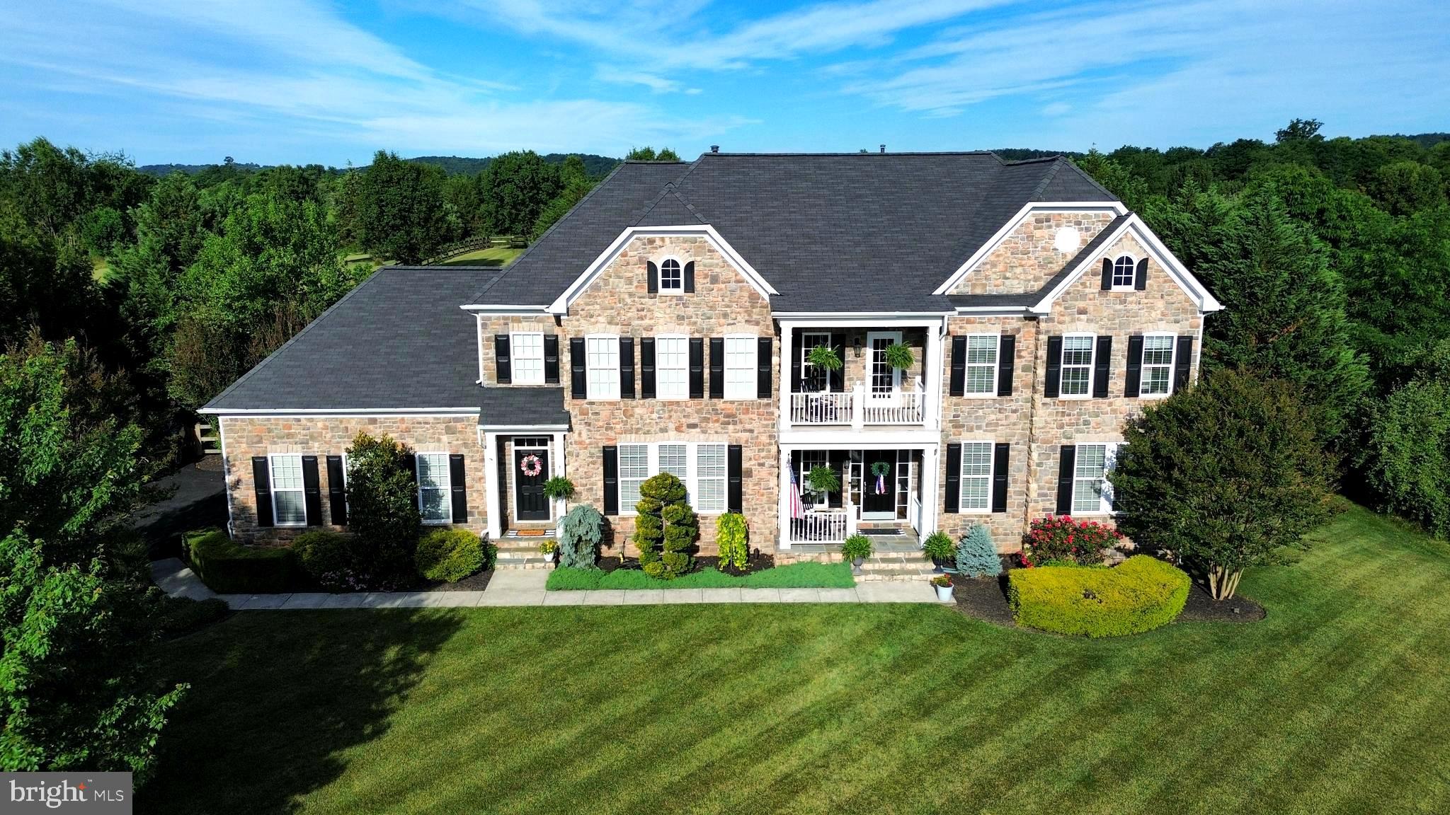 Rare opportunity in Raspberry Falls — only the second home offered for sale in the community this year. Perfectly positioned on a private, golf-course lot of more than an acre, this impressive stone-front estate was designed for those who love to gather, entertain, and enjoy both indoor and outdoor living at its finest.

Imagine hosting holiday dinners and milestone celebrations around the spectacular gourmet kitchen, where a dramatic 13-foot center island becomes the natural gathering place for family and friends. Mornings begin in the sun-filled breakfast room surrounded by walls of windows, while evenings flow seamlessly outdoors to the extensive patio area. As the seasons change, enjoy football Saturdays and crisp autumn evenings gathered under the patio pavilion with overhead heaters, lighting and a stone wood-burning fireplace, creating the perfect setting for memorable nights together. 

When it's time to continue the celebration, the fully finished lower level delivers an exceptional entertainment experience. A custom wet bar featuring handsome design elements overlooks a spacious game room and recreation area, providing the ideal backdrop for game nights, movie marathons, holiday parties, and special occasions. The lower level also offers a dedicated home gym, hobby or arcade space, and guest powder room, plus a private sixth bedroom with full bath—perfect for overnight guests, extended family, or an au pair suite.

Offering close to 7,400 finished square feet across three beautifully finished levels, the home features five upper-level bedrooms, including four with private en-suite baths.   The primary suite offers space to unwind in the separate sitting area with 3-sided gas fireplace and wet bar, a large primary bath with 2 separate vanities, 2 enclosed water closets and 2 separate walk-in closets.   The main level showcases hardwood flooring, a private office or library, formal living and dining rooms, and an open-concept kitchen that seamlessly connects to the breakfast room and family room.

Outside, the setting is equally impressive. Backing to the golf course and adjoining a conservation area, the property enjoys exceptional privacy and views.  

Raspberry Falls is one of Loudoun County's most sought-after neighborhoods, known for its unique hamlet-style design where intimate clusters of homes are connected by expansive open space, scenic landscapes, and the award-winning golf course. Just 10 minutes from Historic Leesburg, residents enjoy convenient access to boutique shopping, acclaimed restaurants, wineries, breweries, and the nearby W&OD Trail. Dulles International Airport, Herndon and Reston all offer a 30-minute commute.   The recently replaced roof and HVAC systems offer peace of mind for years of worry-free low-maintenance living!

A rare combination of luxury, privacy, and exceptional entertaining spaces—inside and out.  This is one of those truly special homes that simply do not come to market often.