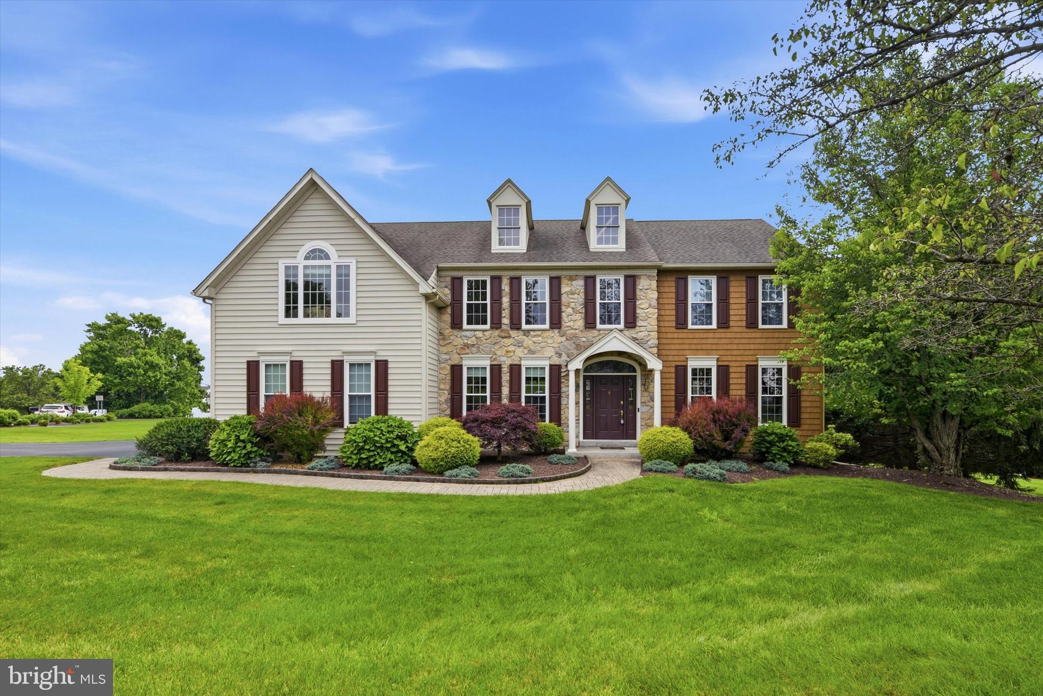 Offered for the first time by its original owners, this beautifully maintained colonial is perfectly positioned on an oversized corner lot in the highly sought-after Kenmara community of West Chester. Thoughtfully updated over the years and meticulously cared for, this move-in ready residence offers over 4,200 square feet of finished living space, 5 bedrooms, 3 full baths, 1 half bath, and an exceptional backyard retreat featuring a private in-ground pool.
 
A dramatic two-story foyer creates an inviting first impression, complemented by hardwood flooring that extends throughout most of the main level. Comfortable family room and formal dining roomprovide elegant space for entertaining, while dual offices with French doors offer the ideal work-from-home setting or future media room. At the heart of the home, the spacious eat-in kitchen features white cabinetry, a center island with seating, abundant storage, and a sunroom. Sliding glass doors open to the elevated deck, creating the perfect setting for outdoor dining, grilling, or enjoying a quiet morning coffee overlooking the private backyard. Adjacent to the eat-in kitchen and sunroom, the spacious family room is anchored by a wood-burning fireplace and a soaring wall of windows overlooking the backyard and pool.This inviting space is filled with natural light and designed for everyday living as well as memorable gatherings. Conveniently located just off the main living areas are a well-appointed powder room and a spacious laundry/mudroom with custom cabinetry and direct access to the oversized two-car garage.
 
Upstairs, the expansive primary suite serves as a true private retreat, complete with hardwood flooring, a generous sitting area, two walk-in closets, and a beautifully renovated spa-inspired bathroom featuring dual vanities, a freestanding soaking tub, and a frameless glass shower. Three additional generously sized bedrooms and a well-appointed hall bath complete the second floor.
 
The fully finished walkout lower level significantly expands the home's living space and offers exceptional flexibility. Featuring a large recreation room, wet bar, full bedroom, full bath, and direct access to the pool and patio, it is perfectly suited for entertaining, extended family, guests, an au pair, or multigenerational living. Two large unfinished storage areas provide outstanding storage and/or workout space.
 
Outside, the backyard is designed for both relaxation and entertaining. The recently re-plastered private in-ground pool is surrounded by extensive patio space, mature landscaping, and multiple seating areas, creating a peaceful outdoor retreat for summer gatherings and quiet evenings alike. Beyond the pool, an expansive, level lawn provides abundant space for children and pets to play, recreational sports, or hosting larger outdoor gatherings, offering a rare combination of resort-style amenities and usable yard space.
 
Located just minutes from vibrant downtown West Chester and only a short stroll to East Bradford Park, residents enjoy convenient access to tennis and pickleball courts, playgrounds, walking trails, athletic fields, an amphitheater, and open green space. Kenmara also offers easy access to major commuter routes, Wilmington, King of Prussia, and Philadelphia. Combining timeless design, thoughtful updates, an outstanding floor plan, and an exceptional outdoor living experience, this remarkable home presents a rare opportunity to enjoy the very best of Chester County living.