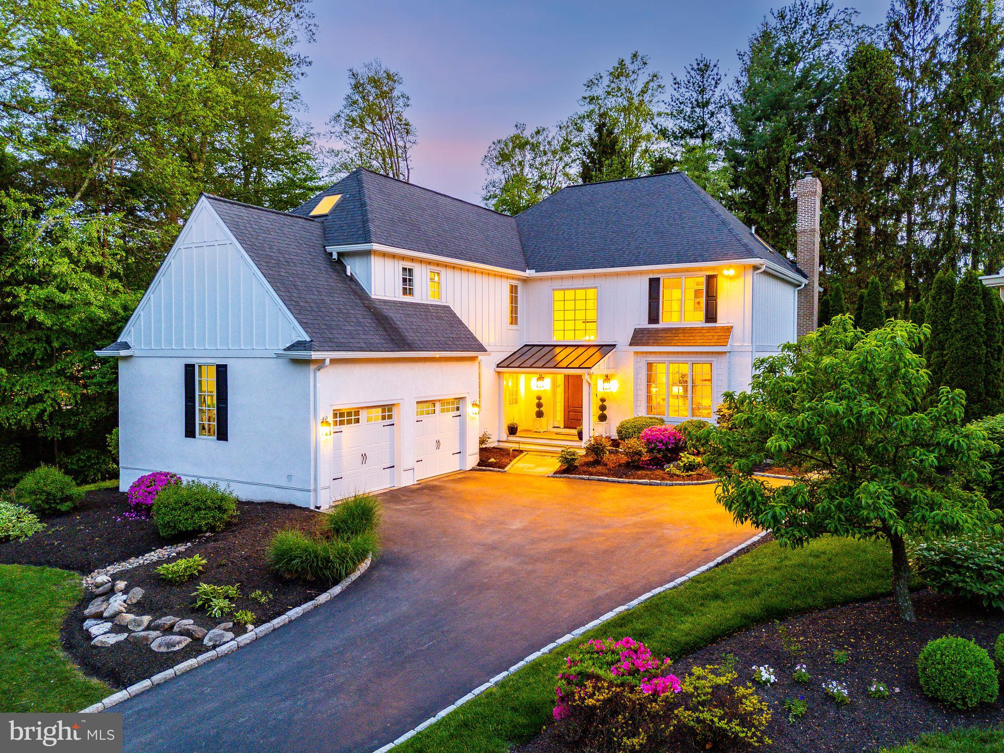 Offered in absolute move-in condition, this beautifully updated modern Colonial in Villanova’s sought-after Trianon community has been meticulously transformed from top to bottom. With all-new Hardie siding, Anderson 400 Series windows, new exterior and garage doors, gutters, and a custom metal-roof portico, this like-new home delivers turnkey luxury and long-term peace of mind. Set on a private, flat, and usable yard surrounded by mature trees, 302 Gramont Lane offers 4 bedrooms, 3.5 bathrooms, and over 5,300 square feet of thoughtfully designed living space in the heart of Radnor Township—just moments from train stations, restaurants, coffee shops, and neighborhood parks.
From the moment you arrive, the home’s crisp white exterior, black shutters, and manicured landscaping create striking curb appeal. Inside, a grand double-height foyer with 10-foot ceilings and sun-drenched windows introduces a refined, light-filled interior curated for elevated daily living.
To the right, a formal living room with a gas fireplace and bay window offers a warm and elegant setting for guests. To the left, a private home office with custom built-ins is perfect for remote work. A stylishly redone laundry and mudroom (2019) connects directly to the attached two-car garage, combining form and function.
The formal dining room flows into a chef’s kitchen that was completely reimagined in 2019. Outfitted with Thermador and Bosch appliances, quartz countertops, a Carrara marble backsplash, custom cabinetry, under-cabinet lighting, and a bar with wine fridge, this space is ideal for both entertaining and everyday cooking. A sunlit breakfast nook beneath a skylight opens to the spacious family room, anchored by a floor-to-ceiling stone fireplace and French doors leading to a private flagstone patio (2020)—perfect for al fresco dining and gatherings.
Upstairs, the serene primary suite offers expansive windows, detailed millswork, two walk-in closets, custom blackout shades, and a luxurious marble bath (2021) with heated floors, soaking tub, dual vanities, skylight, glass-enclosed rain shower, and private water closet. Three additional bedrooms—each with recessed lighting, generous closet space, and blackout window treatments—share two freshly renovated full bathrooms (2024) featuring designer tile and quartz finishes.
The expansive lower level adds over 1,200 square feet of versatile living space—ideal for a gym, media lounge, or playroom—and includes a framed and plumbed fifth bedroom with a rough-in for an additional full bath, offering excellent potential for future expansion.
Major upgrades include brand-new Hardie siding, Anderson 400 Series windows with a transferable lifetime warranty, new gutters, garage and entry doors, and a custom portico with standing seam metal roof (2025). The home also features a 10-year warranty roof by O'Donnell Roofing (2018), a high-efficiency hot water heater (2020/2021), a dual-zone HVAC system serviced twice annually, and updated fireplaces with repointed chimneys (2020). Additional enhancements such as fresh paint, all-new hardwood flooring, and sophisticated lighting elevate the home’s overall design and livability.
Set apart as the only home in the Trianon community surrounded on three sides by mature trees, the property offers exceptional privacy and serenity. A flat, landscaped yard and a peaceful, park-like setting across the street enhance the outdoor lifestyle. With HOA-covered grounds and shared landscaping, this is truly low-maintenance Main Line living at its best.
Enjoy walkability to Villanova’s Refectory, La Colombe, playgrounds, and the train station, with easy access to downtown Wayne, Bryn Mawr, and top-rated Radnor Township schools and Agnes Irwin. For commuters and convenience seekers alike, both Center City Philadelphia and King of Prussia are easily accessible—offering world-class dining, shopping, and cultural destinations within convenient reach.
