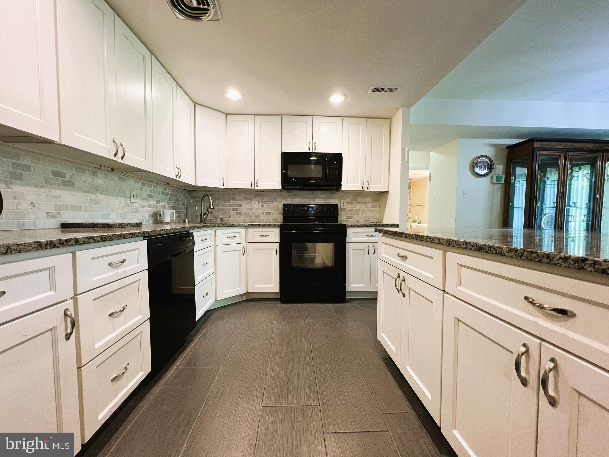 One-of-a-kind ground level terrace, fully updated 2BR 2BA unit, granite kitchen with island and black stainless steel appliances.  NO STEPS, just walk right in through the side entrance or the sliding glass doors.  Instead of a tiny balcony, enjoy the entire stretch of land with grass, trees, and park benches every time you walk outside.  No need to climb steps or wait for an elevator.  Luxury living at its best!  You will also enjoy extra large bedrooms, oversized closets, central AC, new carpet and paint, washer/dryer, additional storage room, plenty of parking, tight security, and everything else the Elmont has to offer.