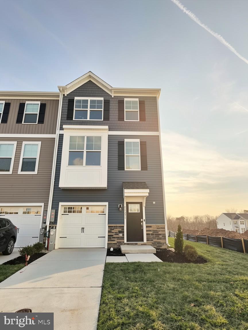PRICE IMPROVEMENT ON THIS STUNNING END OF GROUP W/ WALK-OUT LOWER LEVEL 

Discover The Abigail — a stunning one-car garage luxury townhome that’s as beautiful on the outside as it is inside. With eye-catching Craftsman-style elevations, rich colors, and elegant stone accents, this home offers unbeatable curb appeal.

Step inside to find space in all the right places, thanks to a 4-foot extension on all three levels. This impressive floor plan features 3 bedrooms, 3.5 baths, and a wealth of stylish details throughout.

The main living level boasts an open, light-filled design, perfect for both entertaining and everyday living. The oversized kitchen island with waterfall edges takes center stage, while the spacious great room with fireplace, opening to a large 16x10 rear deck  and separate dining area complete the ideal gathering space.

Upstairs, the owner’s suite offers a tranquil retreat with a vaulted ceiling and a private luxury bath. Two additional bedrooms and a second full bath ensure comfort for family or guests. The convenient bedroom-level laundry adds thoughtful practicality not often found in townhomes.

The finished lower level includes a comfortable rec room and an additional full bath, providing flexible space for work, play, or relaxation.

With its thoughtful layout, modern features, and timeless design, The Abigail truly has something for everyone.

✨ Closing Cost Assistance available with the use of preferred lender and title companies.