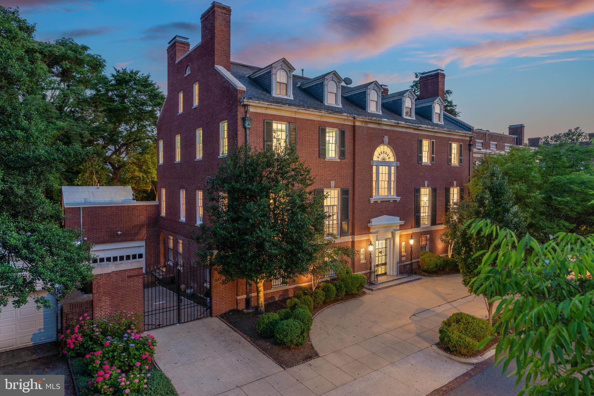 Presenting the crown jewel of Kalorama, a storied 6-bedroom, 7-full bath, 3-half bath mansion gracefully positioned across from beloved Mitchell Park and neighbored by embassies, ambassadorial residences, and some of Washington’s most architecturally and historically significant properties. Built in 1924, this four-story mansion, originally commissioned by Adolf Miller, chairman of the Federal Reserve, is celebrated as an exceptional example of impressive Colonial Revival architecture, featured in the 1928 edition of The Architectural Forum. The mansion, home to many prominent residents since being built, was most recently owned by the inimitable Esther Coopersmith, a diplomat, political lobbyist, and philanthropist, renowned for hosting extraordinary “bridge building” dinner parties, believing in the power of intimate conversation to overcome differences. The mansion’s symmetrical red-brick and limestone façade, grand Palladian windows, and semi-circular driveway welcome you to an expansive, airy interior of nearly 13,000 square feet. The classic center-hall floorplan features dramatically proportioned rooms and exquisitely maintained period architecture, with intricate crown molding and gleaming wood floors throughout. The first two floors serve as the formal and entertaining spaces. The main entry hall is flanked by the formal dining room and reception room, the former being where Ms. Coopersmith used to host her famed dinner parties. A large bedroom, two bathrooms, two powder rooms, kitchen, and elevator complete this level. This home boasts a superb social flow, with the second floor serving as the piano nobile level, with a spacious hall and two grandly proportioned entertaining rooms on the West Wing with nearly 12’ ceilings, ornate fireplaces, and dramatic windows with Juliette balconies overlooking S Street. A family room and large kitchen are conveniently located on the East Wing, and a powder room completes the package. From this main level, walk out onto the wide, south-facing terrace and tiered back patio, complete with fountain, pool, extensive hardscaping, and surrounding gardens offering unrivaled sunlight, privacy, and ample space to entertain. Ascend to the third floor, which hosts the primary suite with an ensuite bath and large dressing room, a spacious second bedroom with adjoining sitting room, an additional bathroom, and a large balcony overlooking the back terrace. The fourth floor offers three additional bedrooms, two baths, and a large cedar closet. Completing this package is a two-car attached garage plus additional parking for 4-5 cars. Available for public sale for the first time in decades, don’t miss this once-in-a-lifetime historic opportunity. This home has wonderful proximity to a diverse set of dining, retail, and entertainment options in Dupont, Georgetown, and the West End. Commute conveniently from Massachusetts and Connecticut Avenues and arrive home to easy parking. This is a home without compromise.