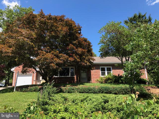 If you are prince charming with some creativity and a few buckets of paint, you can awaken this 3BR brick rancher. All she needs is a little TLC. Set on a beautiful lot with tiered landscaping, the trees act as a canopy of privacy if sitting on the covered back patio or tinkering in the 18x21 detached 2-car garage, with electric, located in the rear of the property. Inside you'll find a living room with a stone wood-burning fireplace; large updated oak kitchen; walk-up attic with floor; partially finished lower level with family room featuring bar and a gas fireplace. A breezeway connects the home and 1-car garage. Some hardwood floors, most replacement windows, new water heater, new gutters and downspouts May 2019, roof approx 13 yrs old, updated furnace and electric. Seller in process of replacing carpet. 1 Year HMS Home Warranty provided to new buyer. Located minutes to West York conveniences, this princess is sure to return your love! AGENTS - Please read Agent Remarks!