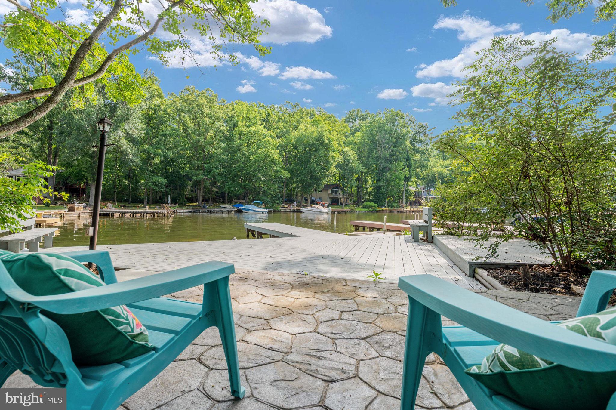 Welcome home to 103 Hillside Drive! Your private retreat in the fabulous community of Lake of the Woods, where every day feels like vacation!
Grab your paddleboard and cruise the cove,  float with friends, fish off your own dock, or just take your pontoon out for a slow ride around this expansive 550-acre lake. This is the life you've been waiting for — and it's all right outside your door!
Step inside and the water views hit you immediately! Warm hardwood flooring flows through the main level and an open layout puts the kitchen, dining, and living room all in one easy flow — all looking out at the lake! The kitchen's been updated, ready for you to cook, host, and entertain family and friends. 
Everyday living? All on the main level — three bedrooms, two full baths, no stairs required. Need more room? Head down to the walk-out lower level for a rec room, a fourth bedroom and full bath.  Perfect for guests, family, or just extra space — it's there when you need it.
Then there's outside...new concrete walkways that take you straight down to your private dock and boat slip. Spend mornings sipping your coffee by the water or evenings watching the sunset knowing that lake life is truly where it's at.   
And this home is ready... new HVAC in 2024, fresh paint and wainscoting, EV/RV hookups,  an electric dog fence, expanded driveway, new walkways, retaining wall, sod, and landscape lighting! Nothing left to do but move in!
Beyond your own backyard, you've got the whole Lake of the Woods lifestyle — a gated community wrapped around a private lake, sand beaches, two marinas, an 18-hole golf course with Fareways Café, two pools, tennis and pickleball, an equestrian center, walking trails PLUS a Clubhouse on the point for dining, concerts and special events!!! This isn't just a house. It's a life you get to step into.
Schedule your private tour today - Lucky at the Lake!