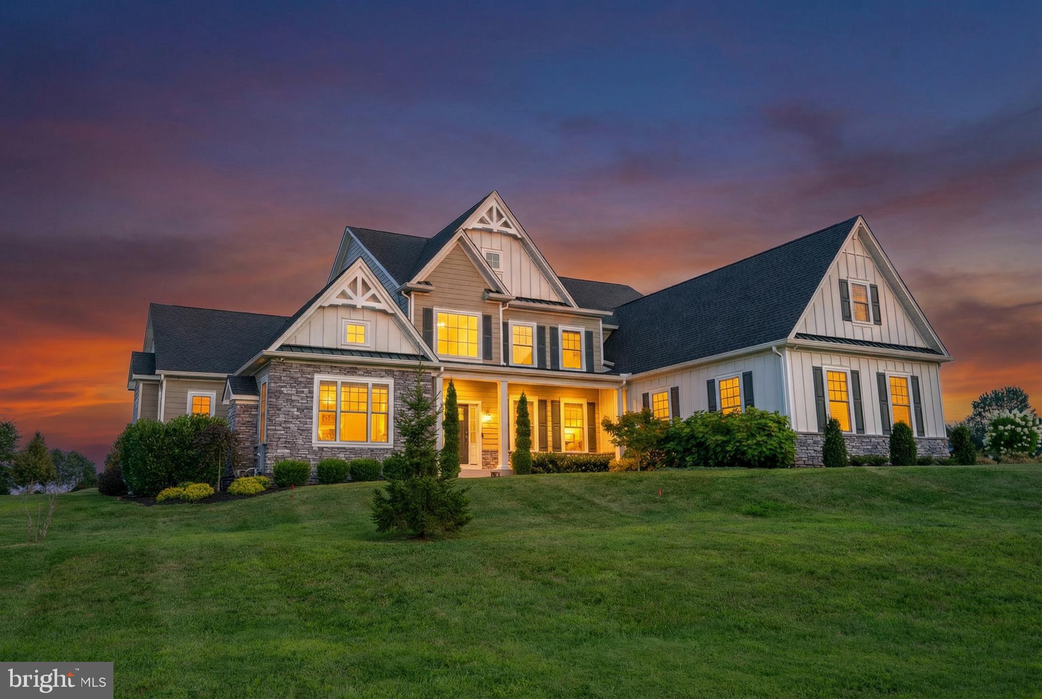 Welcome to 1161 Upper Stump Road, an extraordinary 4-bedroom, 5.1-bath luxury estate perfectly positioned just moments from Lake Galena and tranquil Peace Valley Park, and only minutes from the charm and culture of Doylestown. Set on 2.54 bucolic acres, this remarkable residence blends timeless architecture with today’s most sophisticated amenities, delivering an elevated lifestyle of comfort, elegance, and effortless entertaining. From the moment you enter, the home’s exceptional craftsmanship is evident in the coffered ceilings, bespoke millwork, wide-plank hardwood flooring, and multiple fireplaces that create warmth and character throughout. A fully integrated smart home system enhances everyday living, featuring 9-zone Sonos audio, security, and seamless remote control of lighting, doors, and garage access. At the heart of the home, the gourmet Eat-In Kitchen is both stunning and functional. Custom cabinetry with integrated LED lighting pairs beautifully with professional-grade appliances, including a 60” dual-fuel Wolf range with double griddle, Sub-Zero refrigeration, wine storage, beverage coolers, and more. A dramatic double-thick granite island anchors the space, offering generous seating, storage, and a striking focal point for gatherings.
The first-floor Primary Suite is a private retreat, highlighted by a vaulted ceiling with custom wood detailing, a cozy fireplace, and an expansive custom walk-in closet with organizing system. The spa-inspired bath offers heated floors and towel rack, a soaking tub, dual vanities with built-in storage, and a luxurious dual-entry shower with multiple body jets for a true resort experience. Upstairs, each bedroom features its own en-suite bath, ensuring comfort and privacy for family and guests alike. A spacious bonus loft with custom woodwork and sunlit dormers provides flexible living space perfect for a lounge, office, or creative retreat.
The fully finished lower level, spanning approximately 2,400 square feet, is designed to impress. Styled as an authentic Guinness-inspired Irish pub, it features a custom walnut bar, tin ceiling, brass foot rail, and premium beverage systems. This level also includes a Dolby 7.1 surround theater, private gym, full bath, and multiple spaces designed for unforgettable entertaining. Need even more space? The unfinished 3rd level is just waiting for your creative ideas: extra bedroom space, media space, flex space, golf simulator, or simply storage space. Outdoor living is equally refined, with a covered patio complete with fireplace, built-in television, ceiling fans, and integrated audio - creating a seamless extension of the home. The beautifully landscaped grounds offer privacy and space to relax, entertain, and enjoy the natural surroundings. There are so many more amazing rooms, features, and useful upgrades in this home that we simply couldn’t fit them all in this description. Please refer to the attached detailed list of upgrades and features for the complete picture of everything this remarkable property offers. Ideally located with convenient access to Philadelphia and New York, this is a rare opportunity to own a truly exceptional property in one of Bucks County’s most desirable settings.