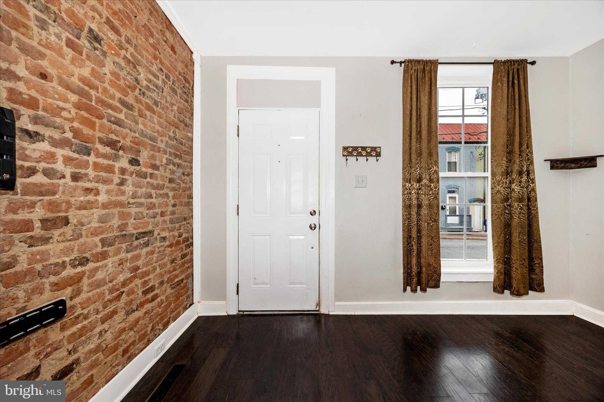 Bavk on the market! Traditional row house at a great location with charm! At front entry, you will be drawn to the the traditional Frederick exposed brick wall and contrasting wood flooring. The living area flows into the dining space and then  into the kitchen. The gorgeous kitchen  has white cabinetry, stainless steel appliances, quartz countertops,  farm sink, and offers access to the rear yard for entertaining or evenings outside. The bathroom features a chic color palette, exposed brick for accent and  heated flooring. Wood flooring continues up the stairs and into both bedrooms. Enjoy the  large storage area tucked away in one of the bedrooms. The unfinished basement has concrete flooring and plenty of storage space and laundry. There is a nicely-sized shed in the backyard.  Brighten up the space  by illuminating the string lights to create a cozy atmosphere and evening twilight. While street parking is available, the next door neighbors have been very courteous and allow the current owners to park on the parking pad right behind the fence. This could potentially be an option for the new owner as well! Immerse yourself in the experience of Downtown living! You are just a short walk from several restaurants, shopping options, breweries,  theater,  as well as Baker Park with all it has to offer! Bask in the charm of historic living, without the historic boundary rules.