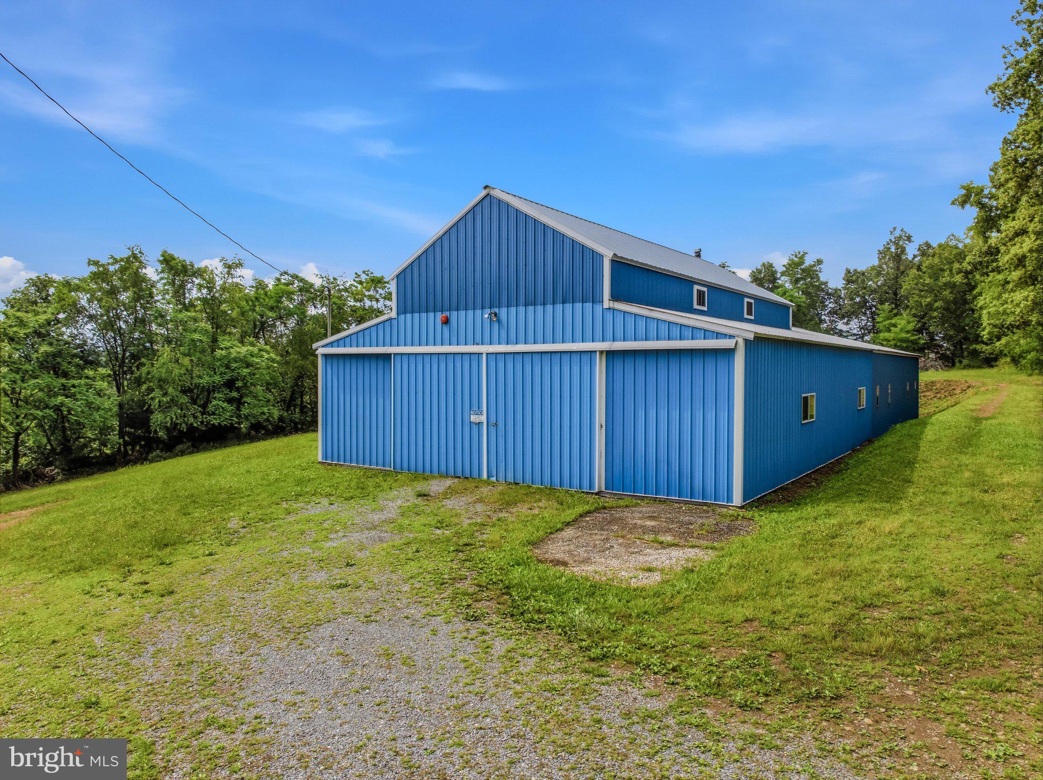 GREAT STORAGE or BUSINESS BUILDIING - don't miss this 36'x96' metal building on 2 acres. This building has all the room you need for your car collection or great for the mechanics dream. Also a great location for keeping your business equipment. Each section is 36'x48 in space. One section having 14' ceilings with a 5 ton lift and also a fireplace for heat. The second section has 9' ceilings and can be accessed from the first section or it has double sliding doors to access from outside. The lot has plenty of room to still build a home or even another building of choice. With a few trees removed you can also get a nice view. The property holds a salvage license and can be transferred to new buyer.