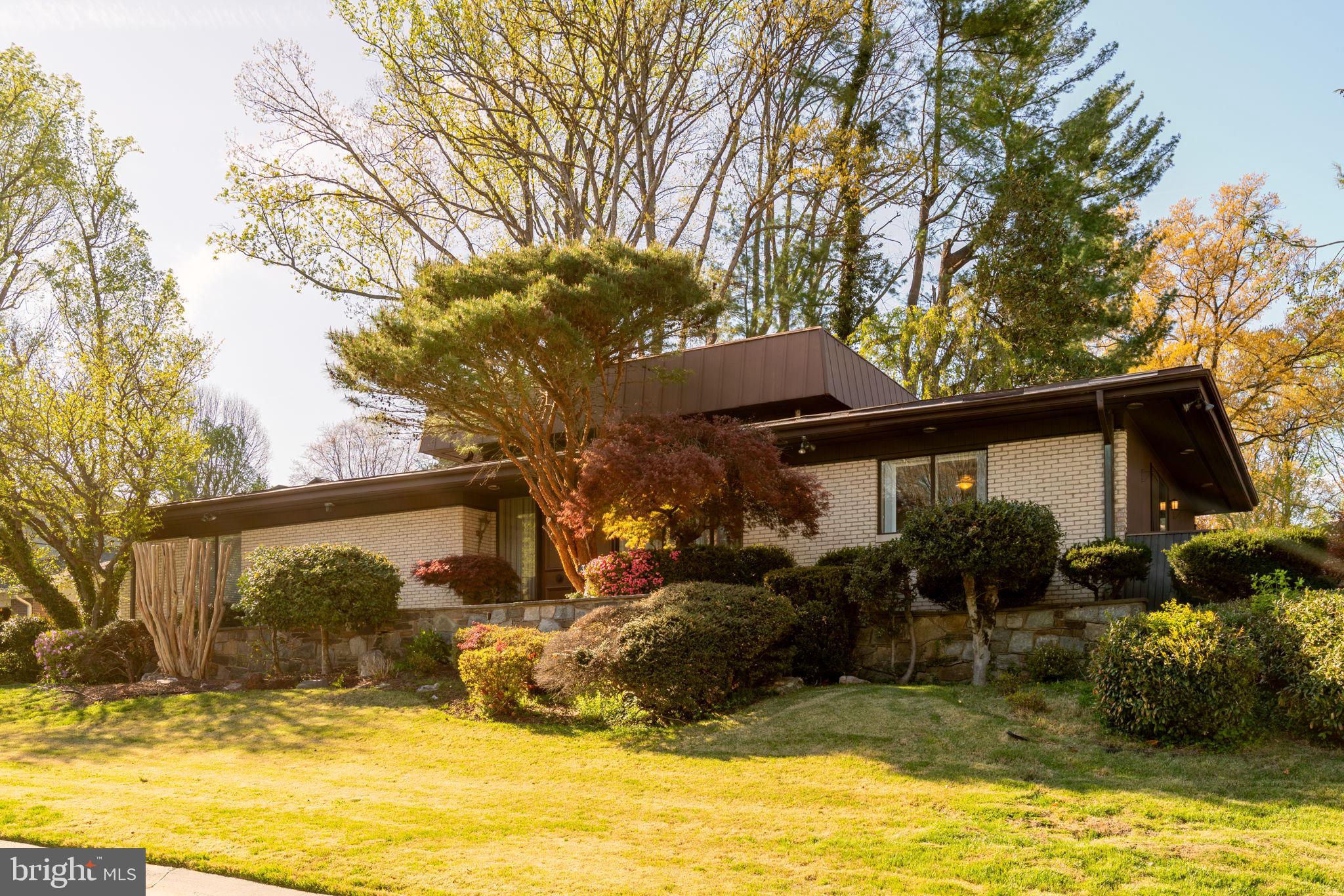 Mid-Century Modern — truly one of a kind. This distinguished 6,200 sq. ft. residence located on a generous corner lot offers a perfectly proportioned layout for refined living and effortless entertaining. The main level welcomes guests with a dramatic foyer beneath 12'6" ceilings, flowing to a formal living room framed by walls of glass that open to sunlit stone terraces and the pool. Host dinners in the elegant dining room overlooking the water, or enjoy casual mornings in the expansive eat-in kitchen and adjoining family room.

The tranquil primary suite features expansive closets, a marble en suite bath, and private patio access; two additional bedroom suites offer walk-in closets and luxurious baths. The lower level is an entertainer’s dream, with a large recreation room with wet bar, access to the two-car garage, an auxiliary kitchen, multiple bedroom/flex spaces, full baths, gym/bonus room, laundry, and ample storage.

Designed for seamless indoor-outdoor living, doors from the living room, family room, and primary suite open to sweeping stone patios and the pool. Located one block from Rock Creek Park and Meadowbrook Stables and minutes from top-rated schools and commuter routes to Maryland, Virginia, and downtown D.C., this impeccably maintained sanctuary is a rare offering.