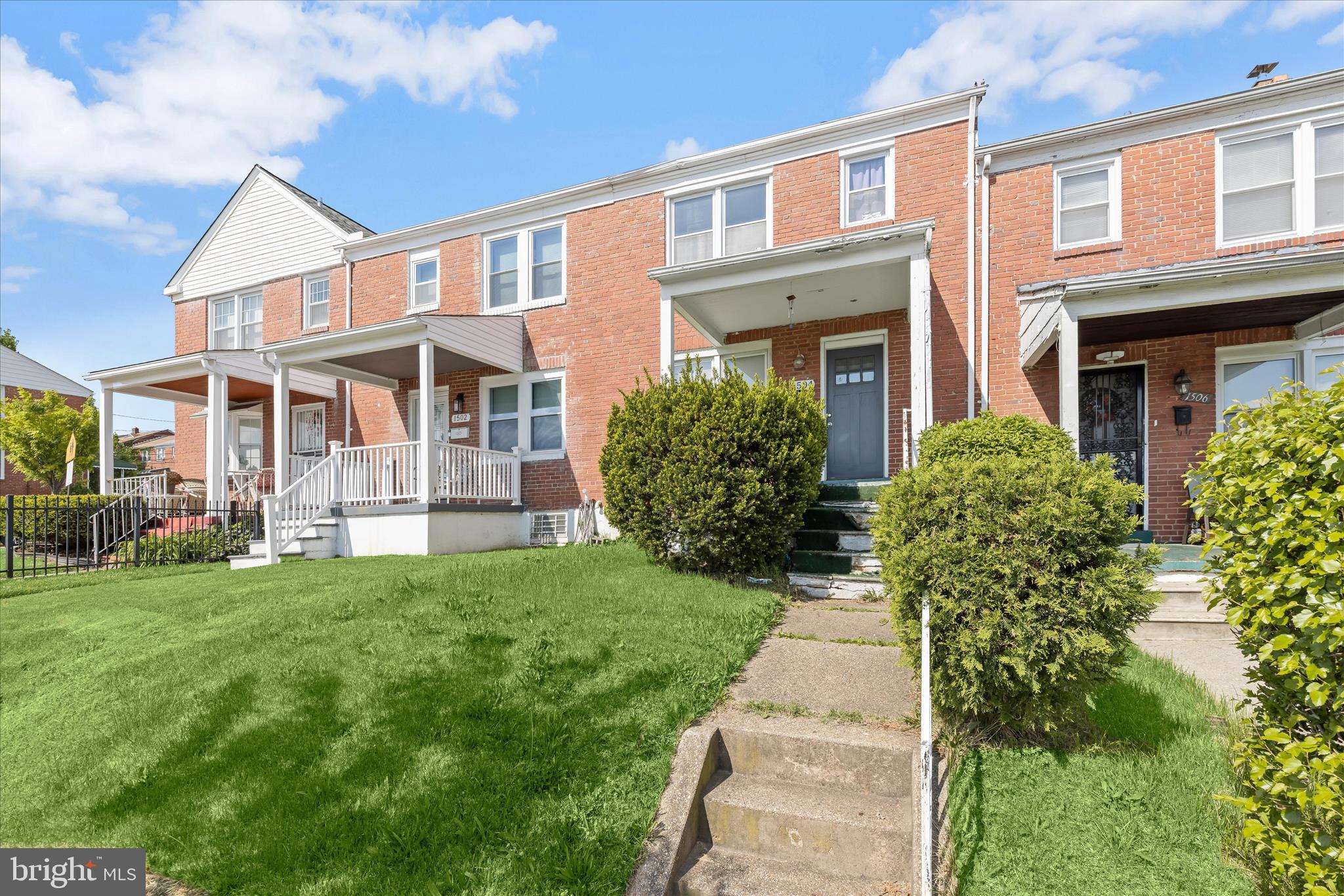 Centrally located in Baltimore City, this classic brick interior townhome offers a blend of timeless character and modern updates. A spacious covered front porch welcomes you into the open-concept living and dining areas, where beautiful hardwood floors and abundant natural light create a warm, inviting atmosphere. The dining room flows seamlessly into the kitchen, featuring granite countertops, shaker-style cabinetry, ample storage, and stainless steel appliances, perfect for everyday living and entertaining.  Upstairs, you’ll find three generously sized bedrooms and a well-appointed hall bath complete with modern tile flooring, subway tile accents, and a convenient linen closet. The finished lower level provides exceptional versatility, offering a comfortable family room with plush carpeting and a full bath, ideal for guests, a recreation space, or multigenerational living.  Outside, the fenced backyard creates a private retreat, perfect for pets or unwinding at the end of the day. Conveniently located near major commuter routes, including I-695, I-95, and I-83, this home combines comfort, functionality, and accessibility.